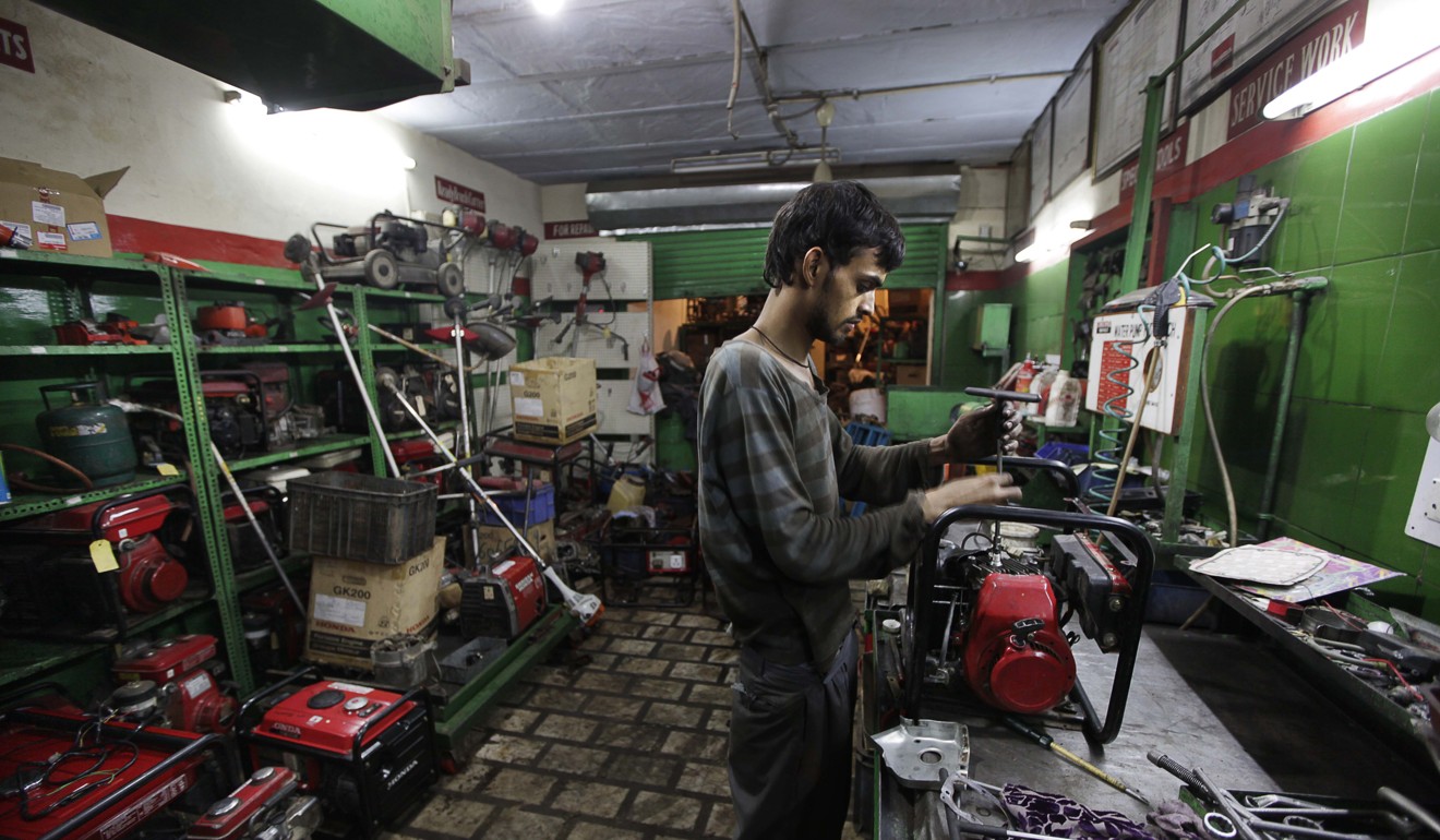 Young Indian men need little more than a secondary school education to find work as a mechanic. Photo: AP