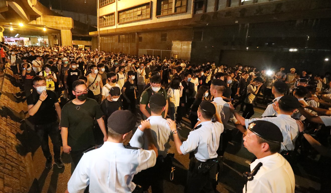 Police officers stop protesters during a march at Tuen Mun on July 6. Photo: Felix Wong