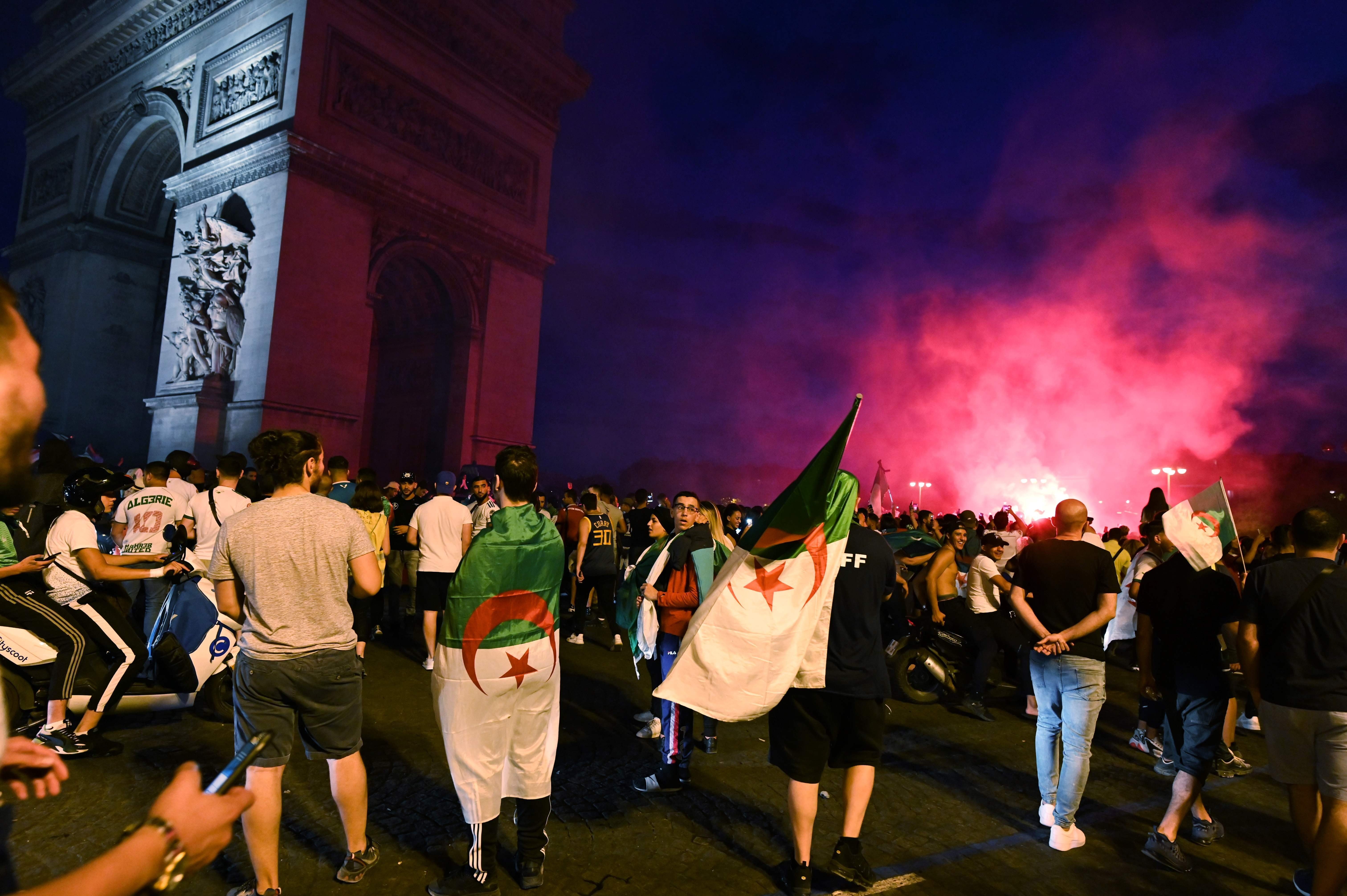 Algerian football fans celebrate the victory of their team near the Arc de Triomphe in Paris. Photo: AFP
