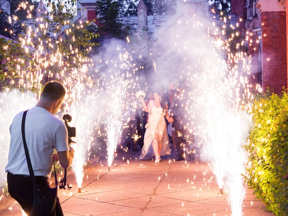 A videographer films a couple’s spectacular exit from a church after their wedding ceremony. Photo: E. Leet/Shutterstock