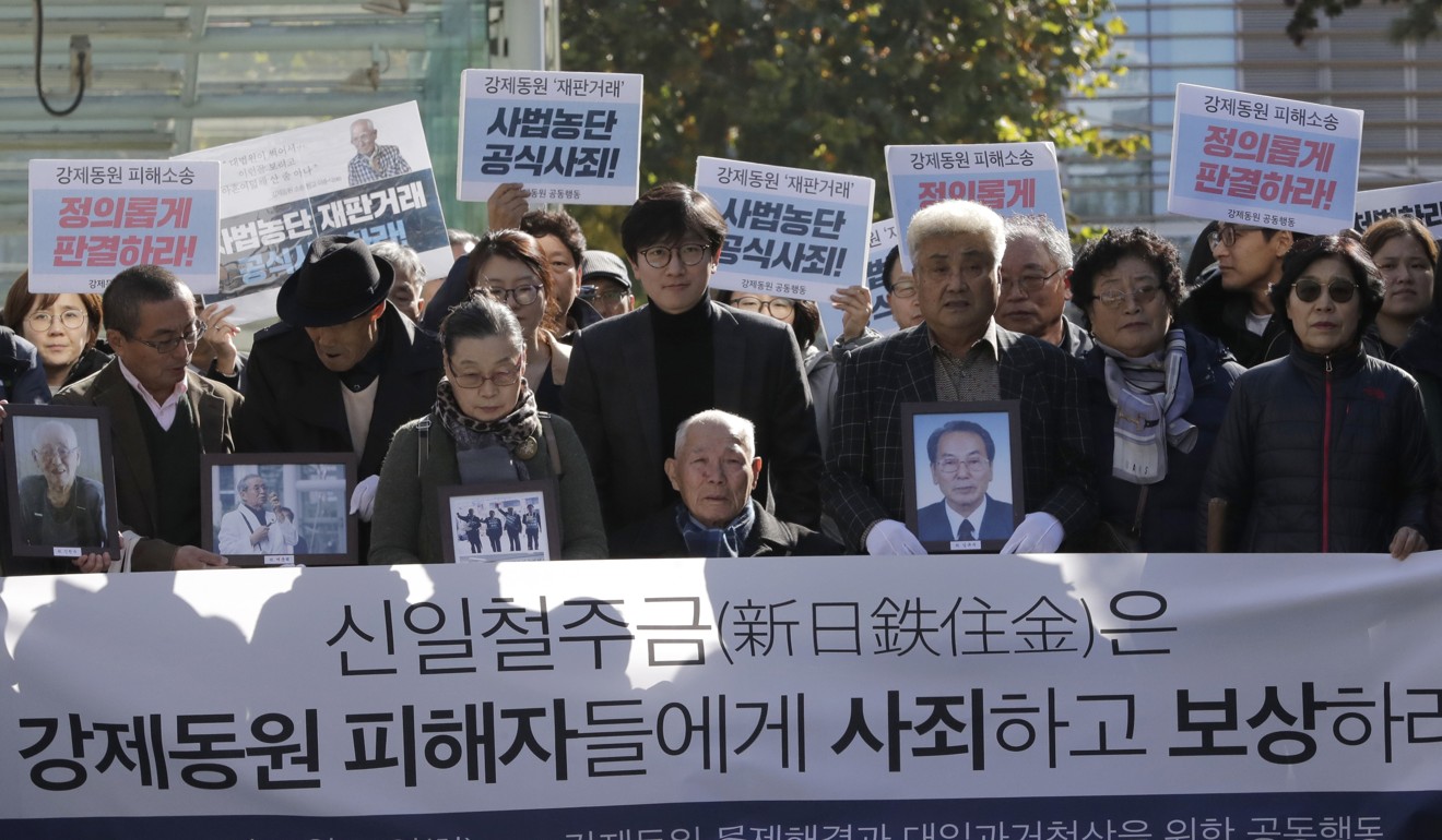 South Korean Lee Chun-sik, centre, a 94-year-old victim of forced labour during Japan’s colonial rule of the Korean peninsula before the end of World War II, arrives at Seoul’s Supreme Court in October 2018. The banner reads: “Nippon Steel & Sumitomo Metal Corporation should compensate and apologise to victims of forced labour.” Photo: AP