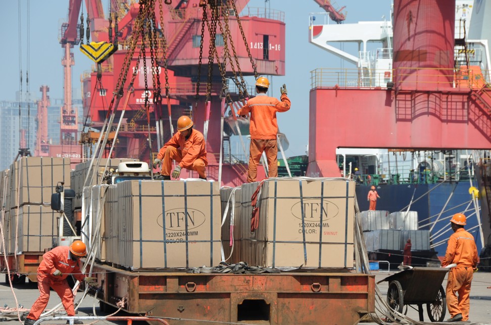 Workers load goods for export onto a crane at a port in Lianyungang, Jiangsu province, China on June 7. Photo: Reuters