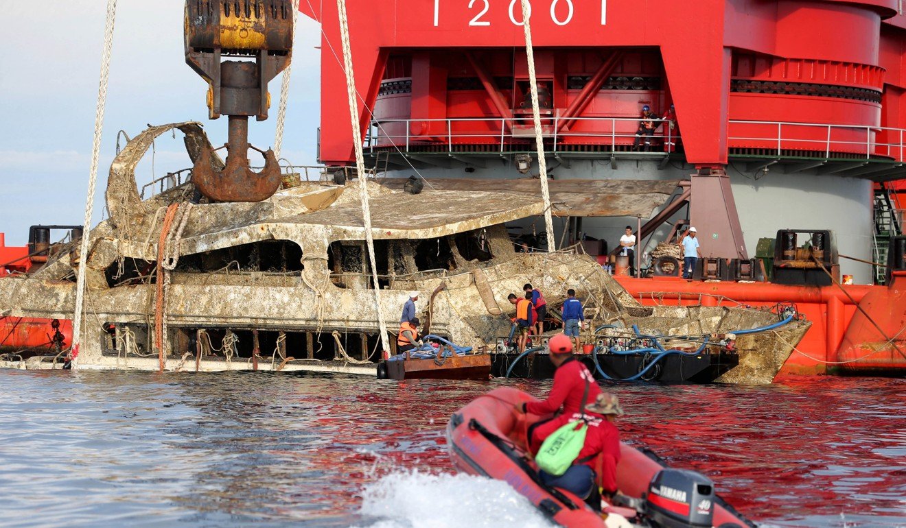 Thai officers salvage the wrecked tour boat that sank last year, killing 47 Chinese tourists. Photo: EPA