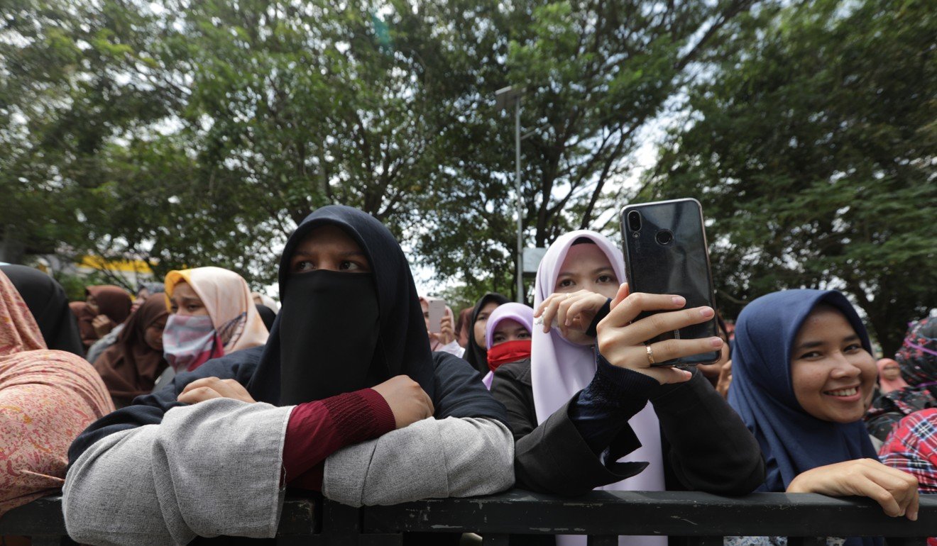 Acehnese women watch a public caning in Banda Aceh earlier this year. Aceh is the only province in Indonesia which has special autonomy to enact sharia-based laws. File photo: EPA