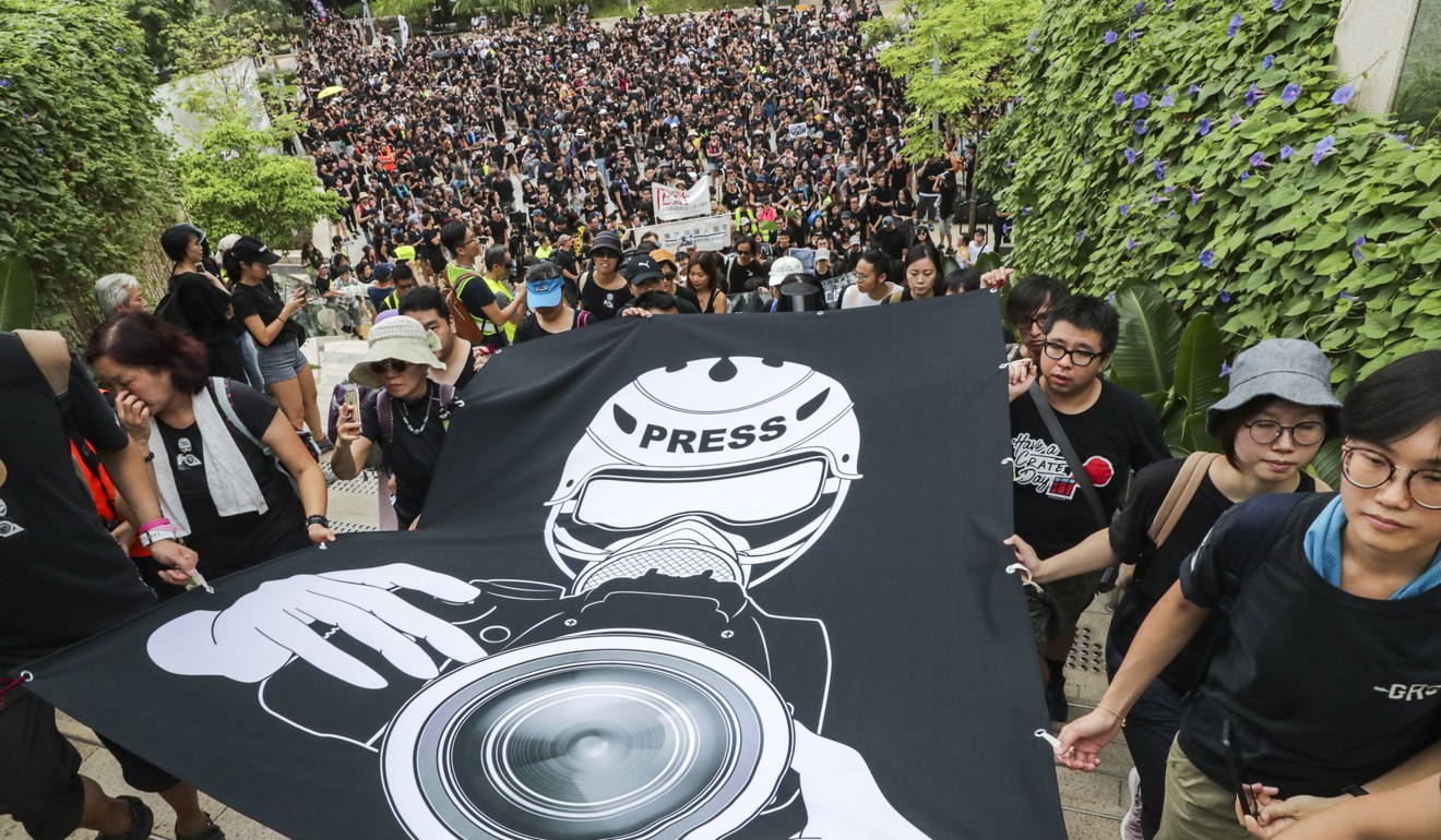 Journalists, press photographers, journalism schoolteachers and commentators take part in a silent march against police violence, from Harcourt Garden to the Hong Kong government headquarters in Admiralty, on July 14. Photo: Edmond So