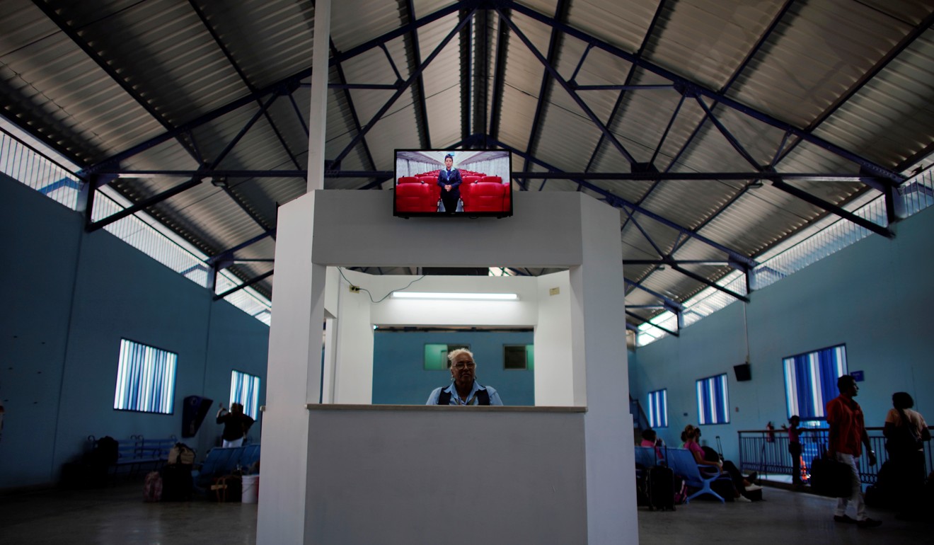 A TV screen displays images of the new Cuba's Chinese-made passenger train at La Coubre railway station in Havana. Photo: Reuters