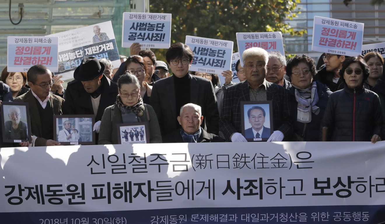South Korean Lee Chun-sik (centre), a 94-year-old victim of forced labor during Japan’s colonial rule of the Korean Peninsula before the end of World War II, sits in a wheelchair outside the Supreme Court in Seoul on October 30, 2018, the day South Korea’s top court ordered Nippon Steel & Sumitomo Metal Corp to pay 100 million won (US$88,000) each to four plaintiffs forced to work for the company during colonisation. Photo: AP