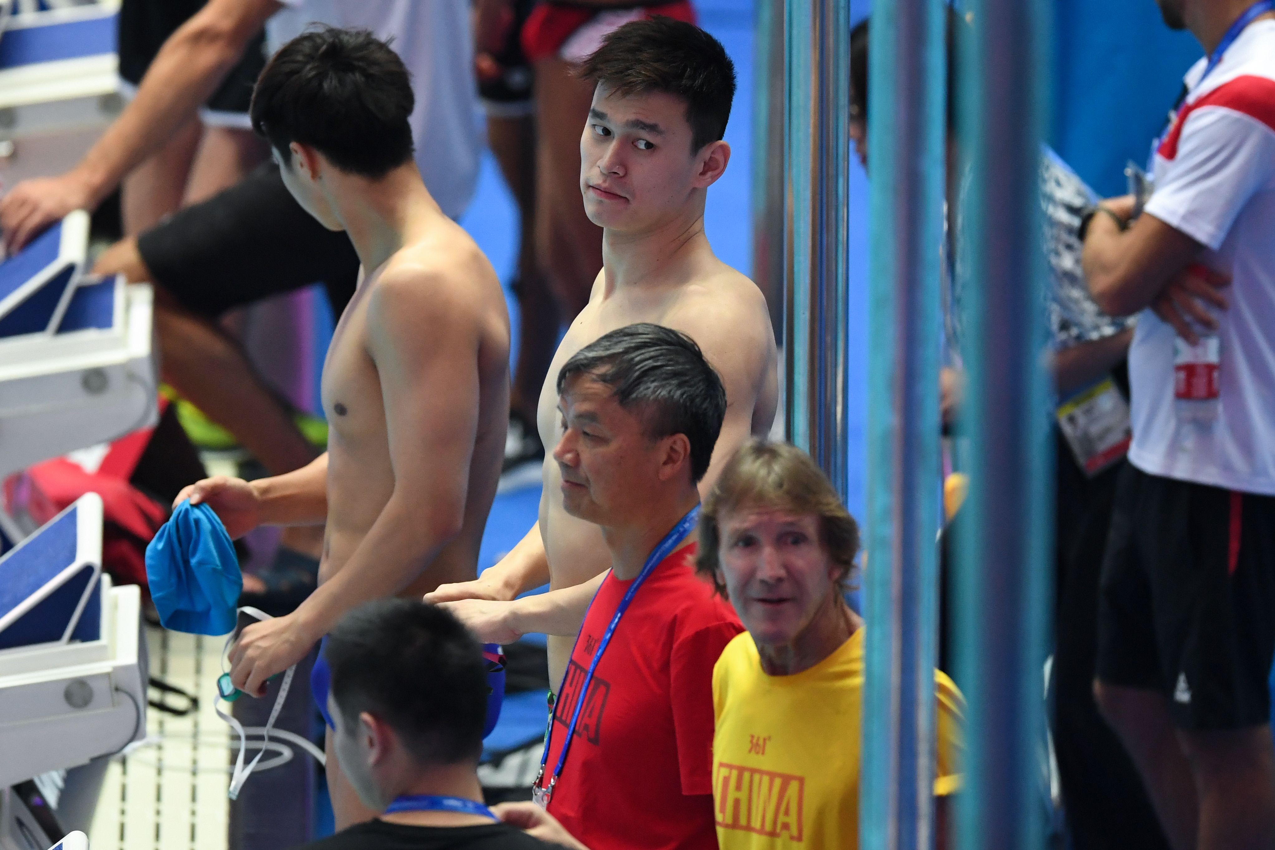 China's Sun Yang (top C) attends a training session with coach Denis Cotterell (foreground). Photo: AFP