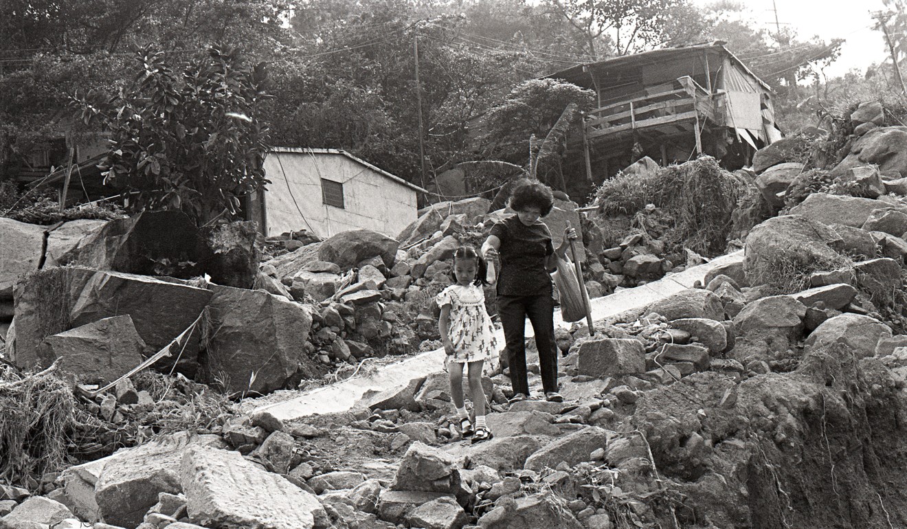A mother and her daughter walk on a damaged footpath in a village in Tsuen Wan in 1978. Hong Kong was much poorer back then. Photo: SCMP Pictures