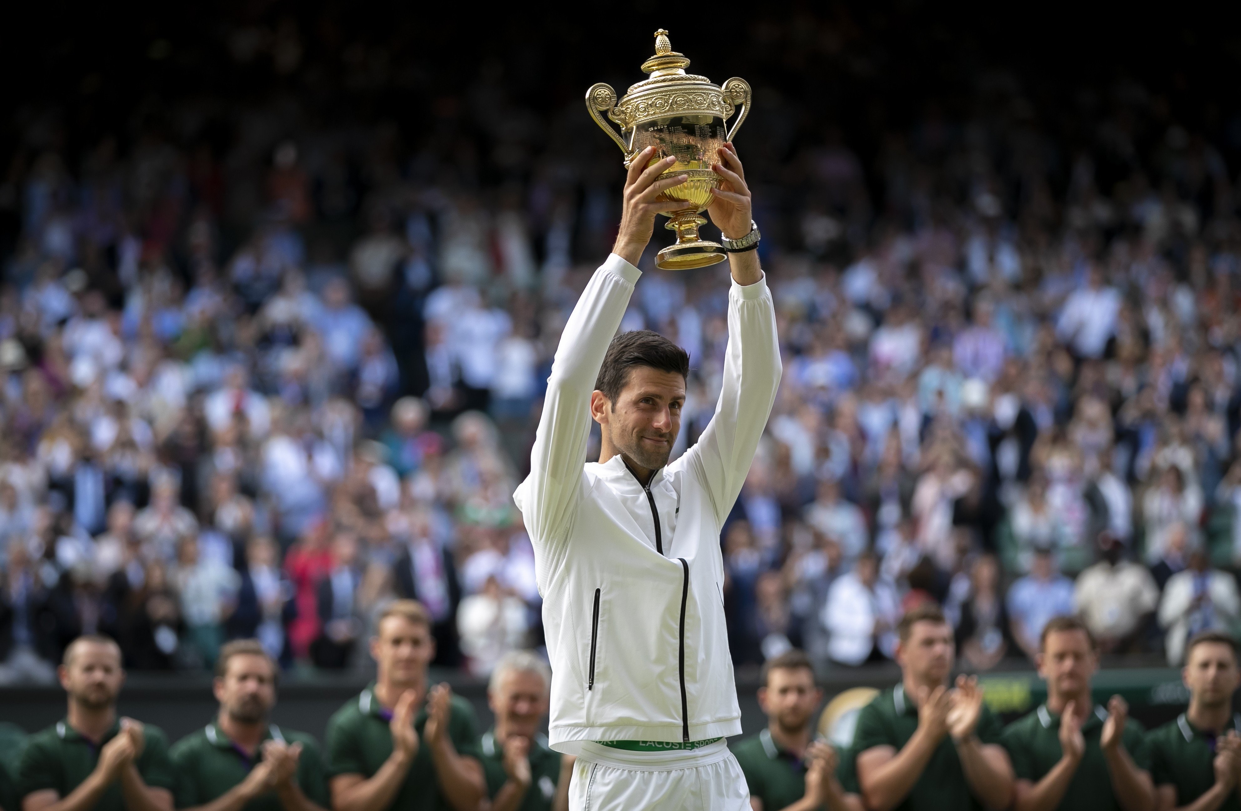 Novak Djokovic of Serbia holds the trophy after winning the men’s singles final against Roger Federer of Switzerland at Wimbledon. Photo: Xinhua