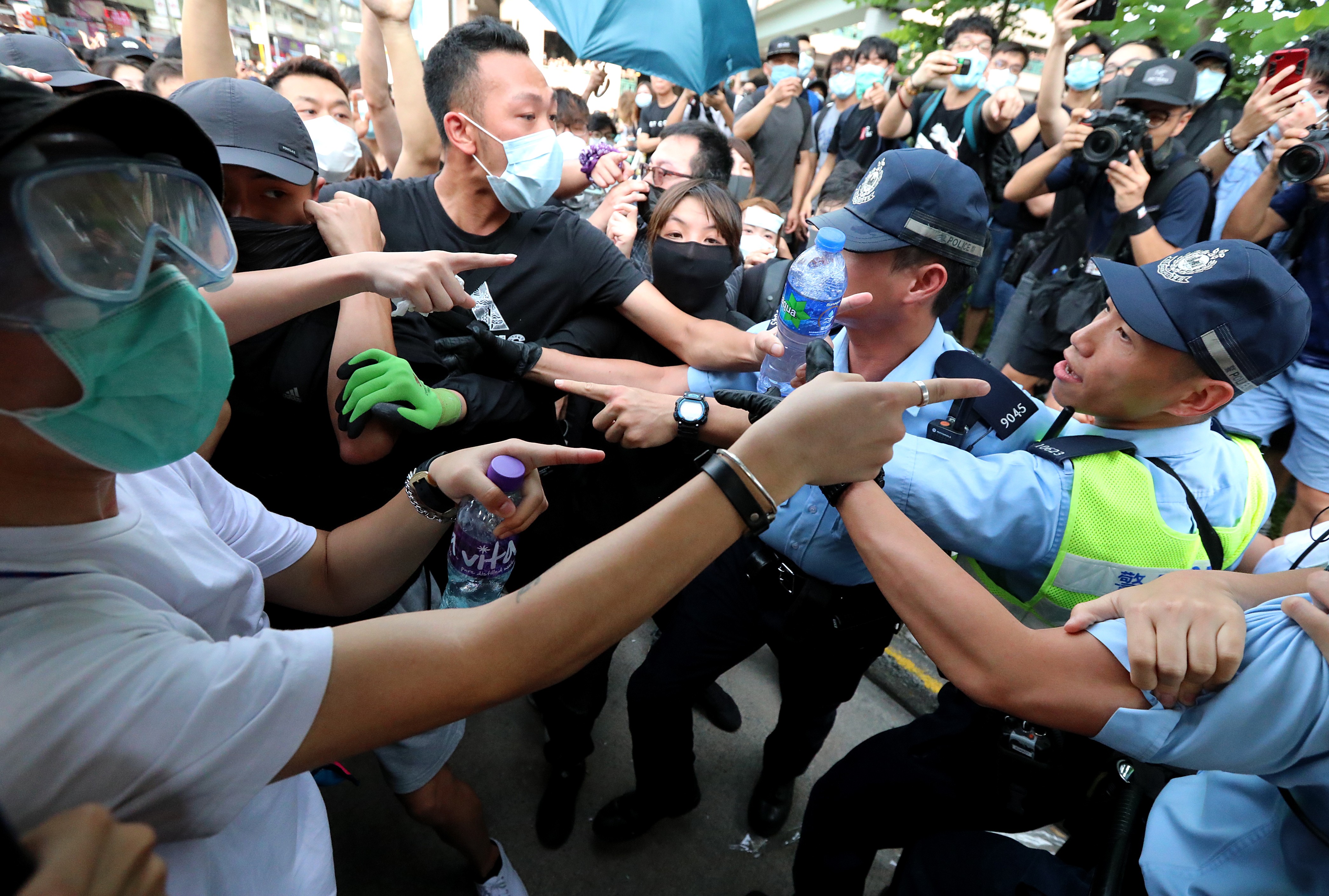 Protesters clash with police after a march against parallel trading by mainland Chinese visitors in Sheung Shui on July 13. Photo: Felix Wong