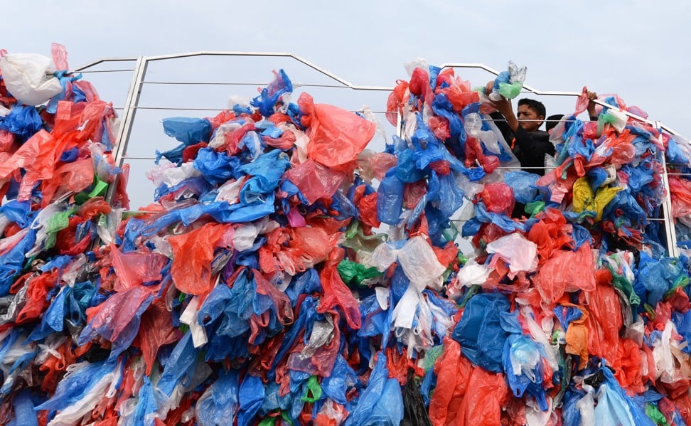 Nepali volunteers and schoolchildren tie up recycled plastic bags to make a sculpture representing the Dead Sea in a bid to set a new world record for the largest sculpture made out of recycled plastic bags in Kathmandu. Photo: AFP