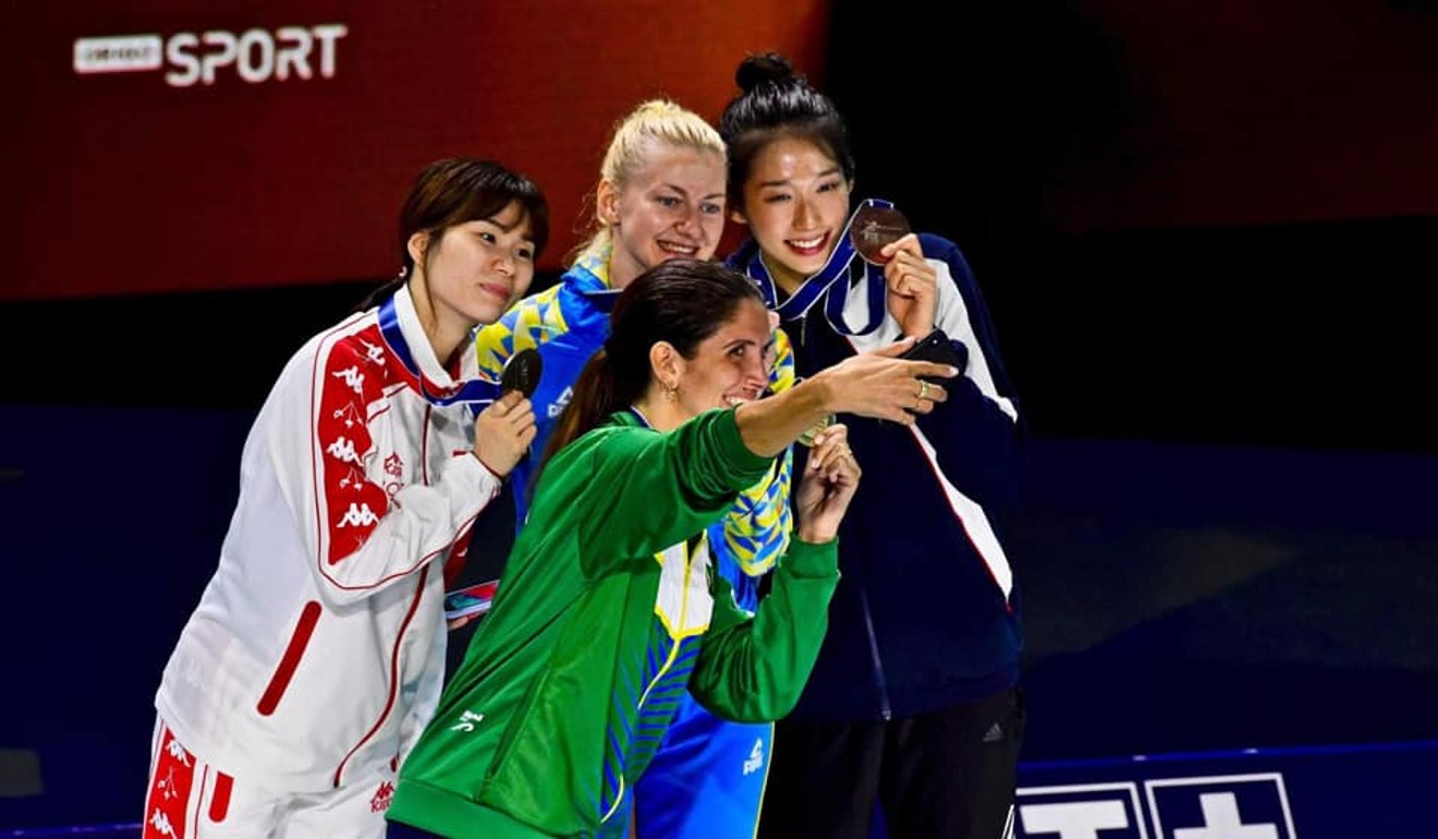 Brazilian gold medallist Nathalie Moellhausen takes a selfie with Vivian Kong (right) and other medal winners. Photo: HKFA/Facebook