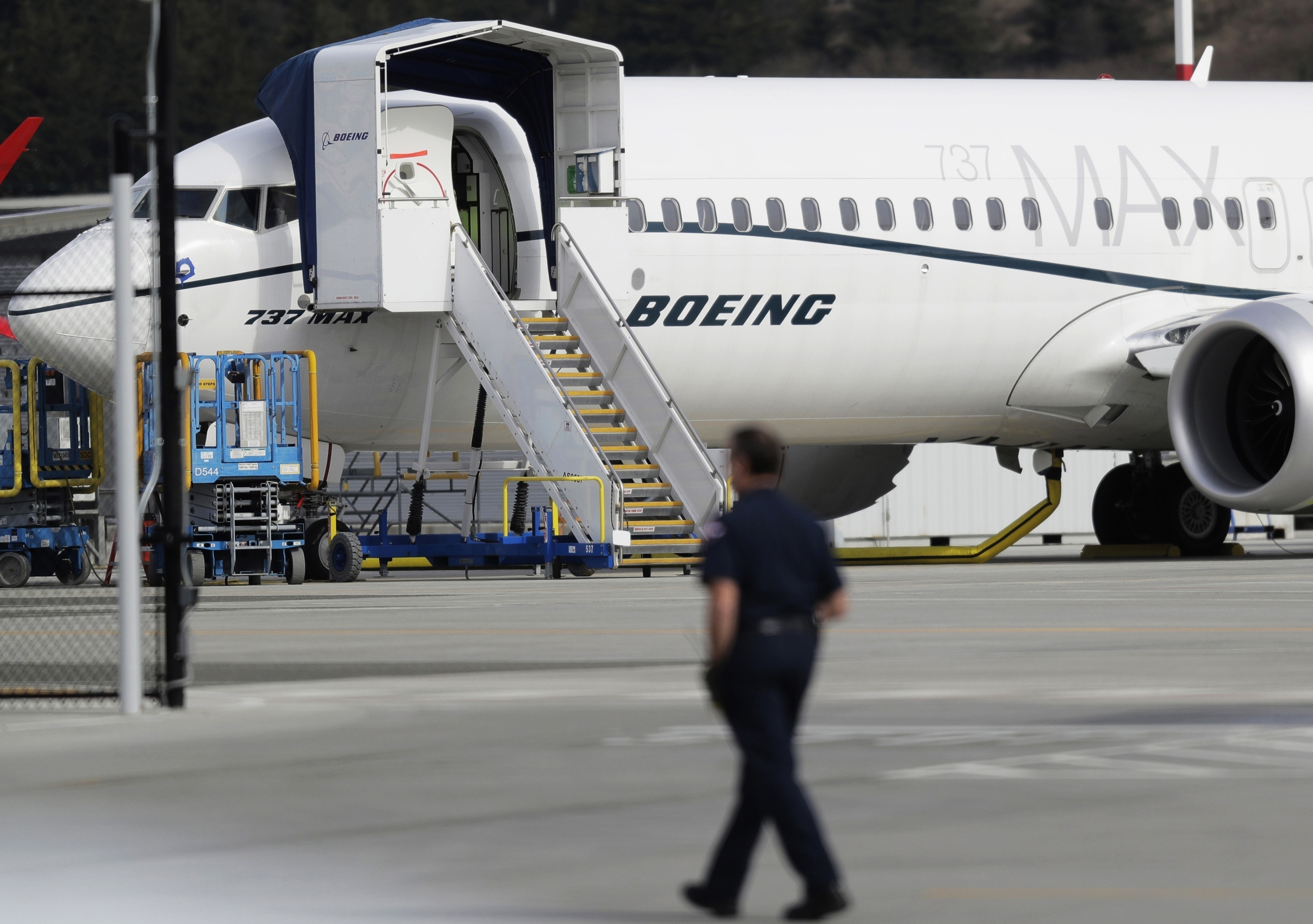 A worker walks next to a Boeing 737 MAX plane at Boeing Field in Seattle. Photo: AP
