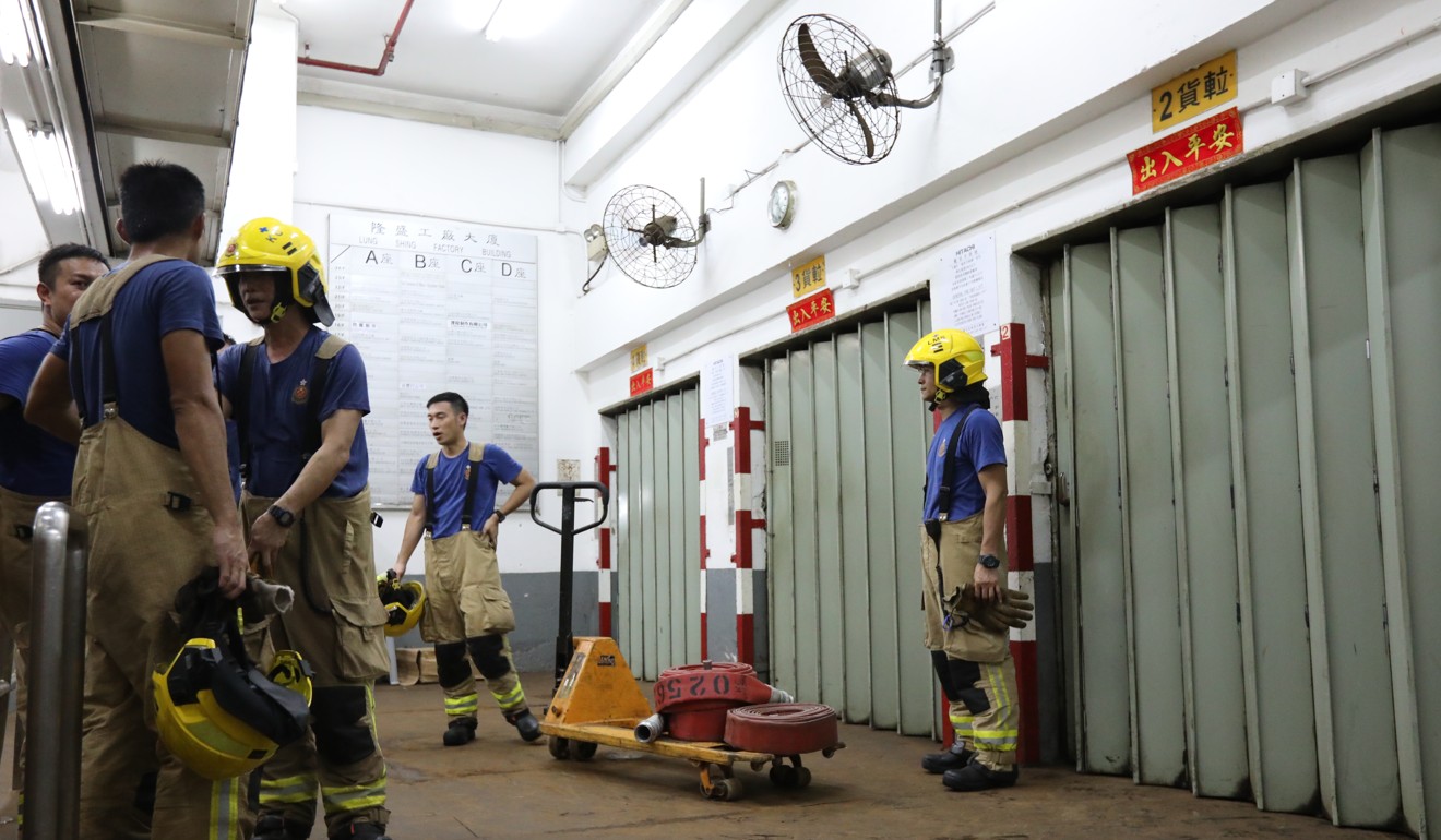Firefighters on standby at the industrial building. Photo: Felix Wong