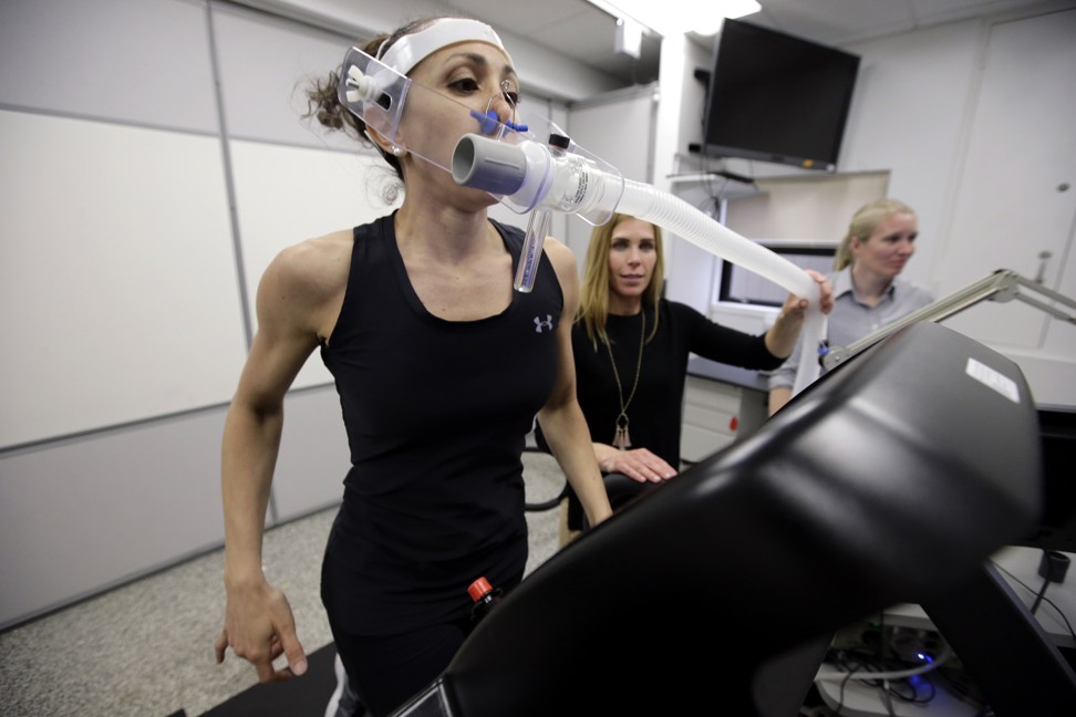 Nutritional physiologist Holly McClung (centre) and research scientist Leila Walker (left) testing equipment designed to evaluate fitness levels of female soldiers. Photo: AP