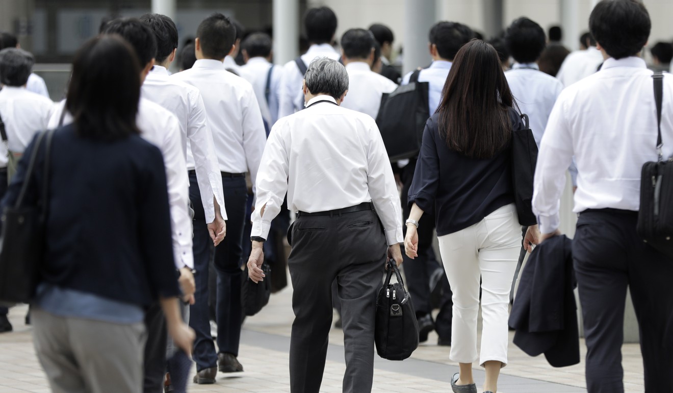 Morning commuters walk along a street in Tokyo. Photo: Bloomberg