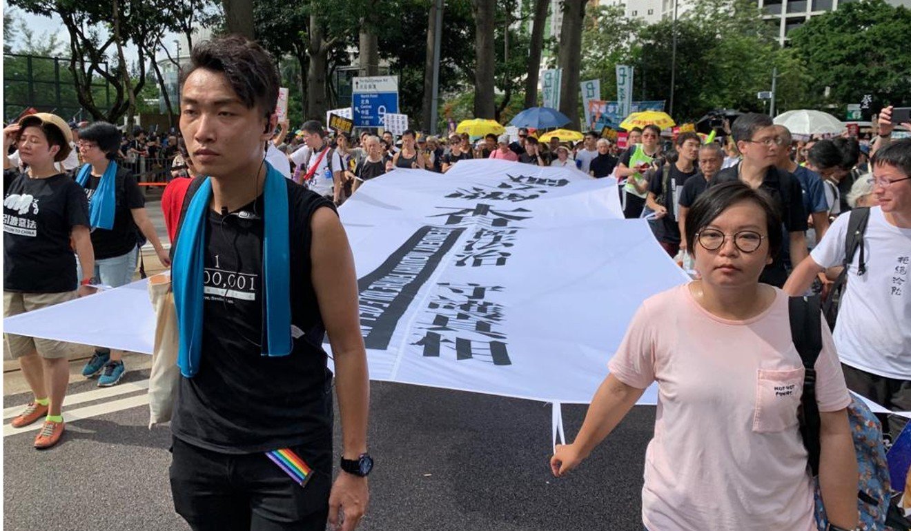 Jimmy Sham (left) from the Civil Human Rights Front was at the head of the march when it started. Photo: Victor Ting