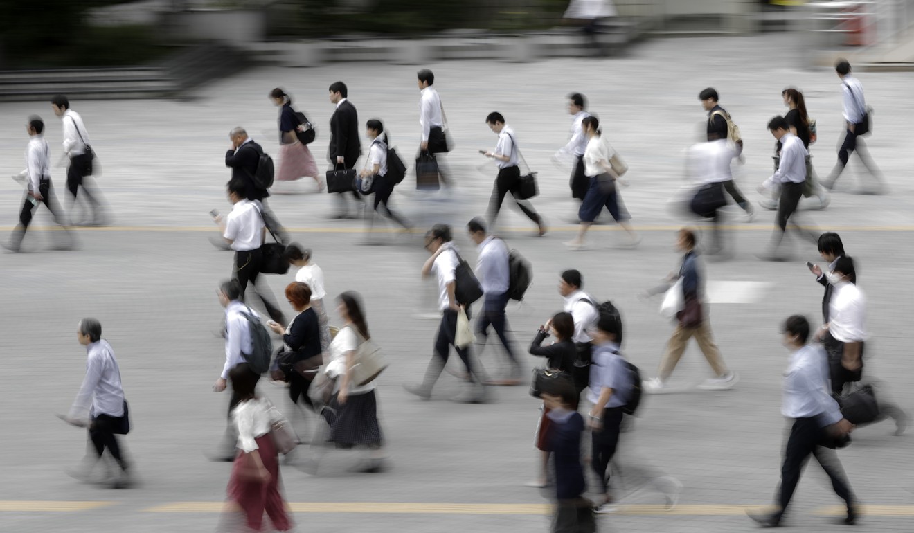 Japanese workers spend more hours at the office than employees in almost any other country. Photo: Bloomberg