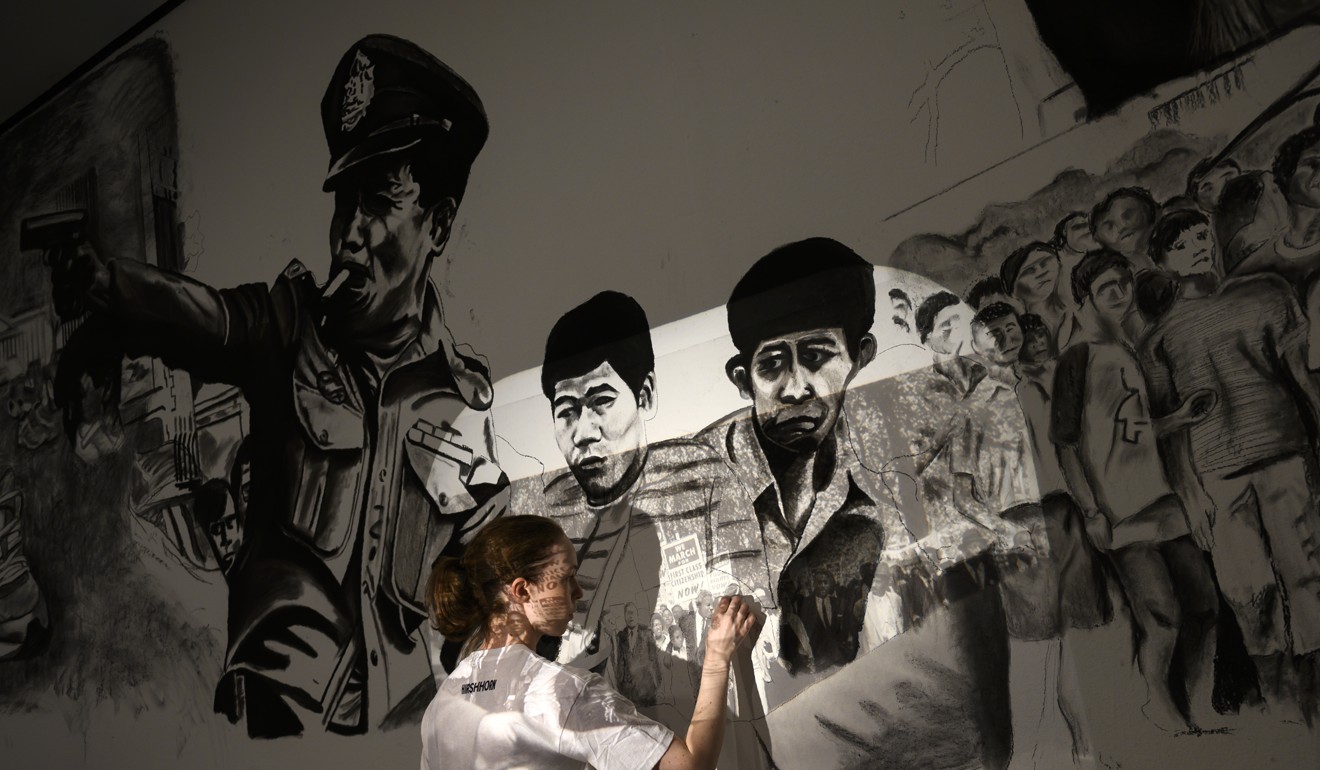 A local artist sketches over a projection at Thai artist Rirkrit Tiravanija’s interactive exhibition. Photo: AFP