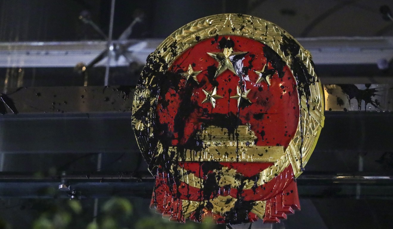 The Chinese national coat of arms defaced by extradition bill protesters at the Liaison Office of the Central People’s Government in Sai Ying Pun on Sunday. Photo: Edmond So