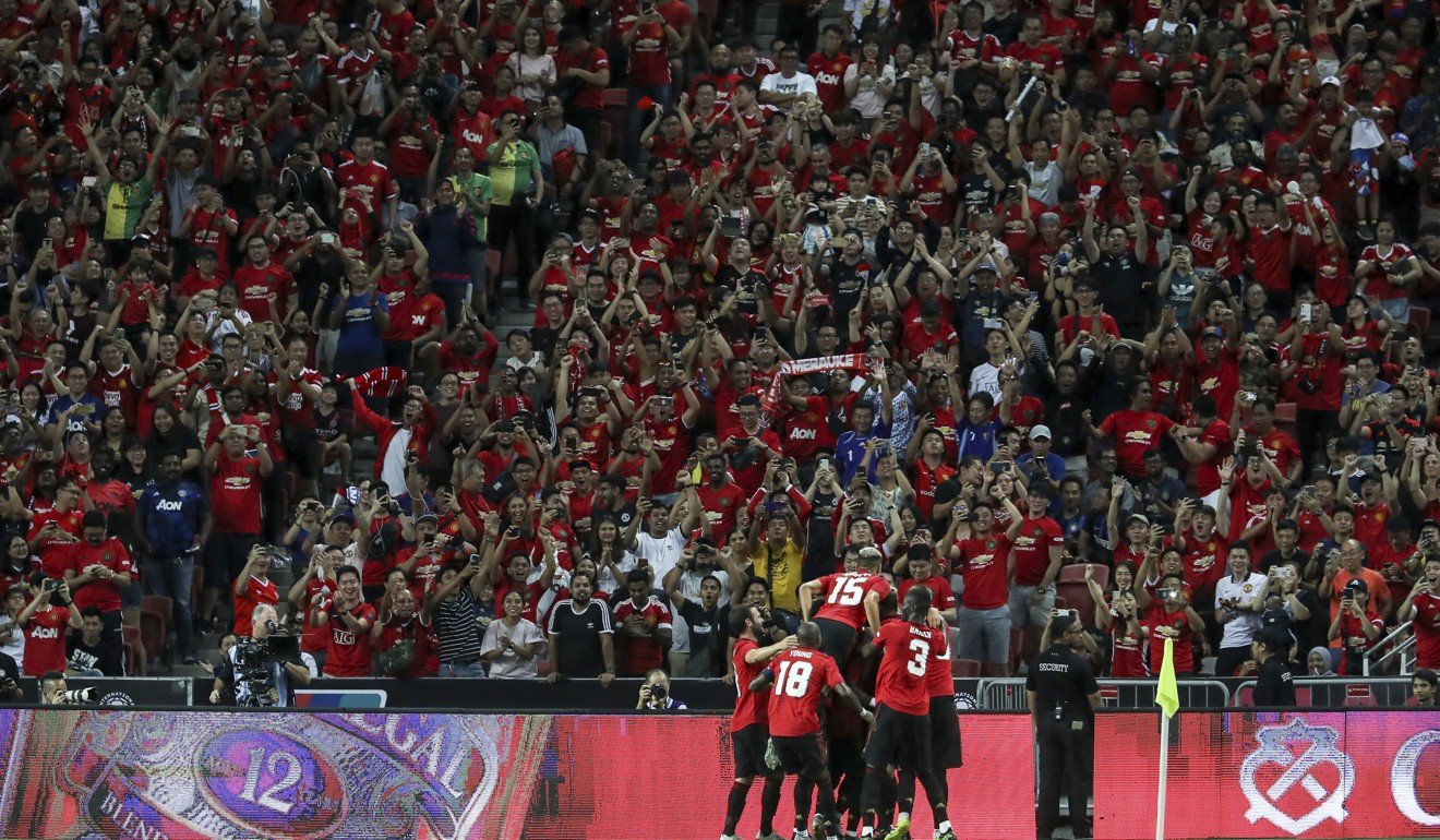 Manchester United’s players celebrate after Mason Greenwood’s goal in front of a packed stadium in Singapore. Photo: AP
