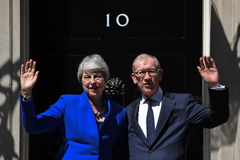 Theresa May, accompanied by her husband Philip, waves from 10 Downing Street for the last time on July 24. Photo: AFP