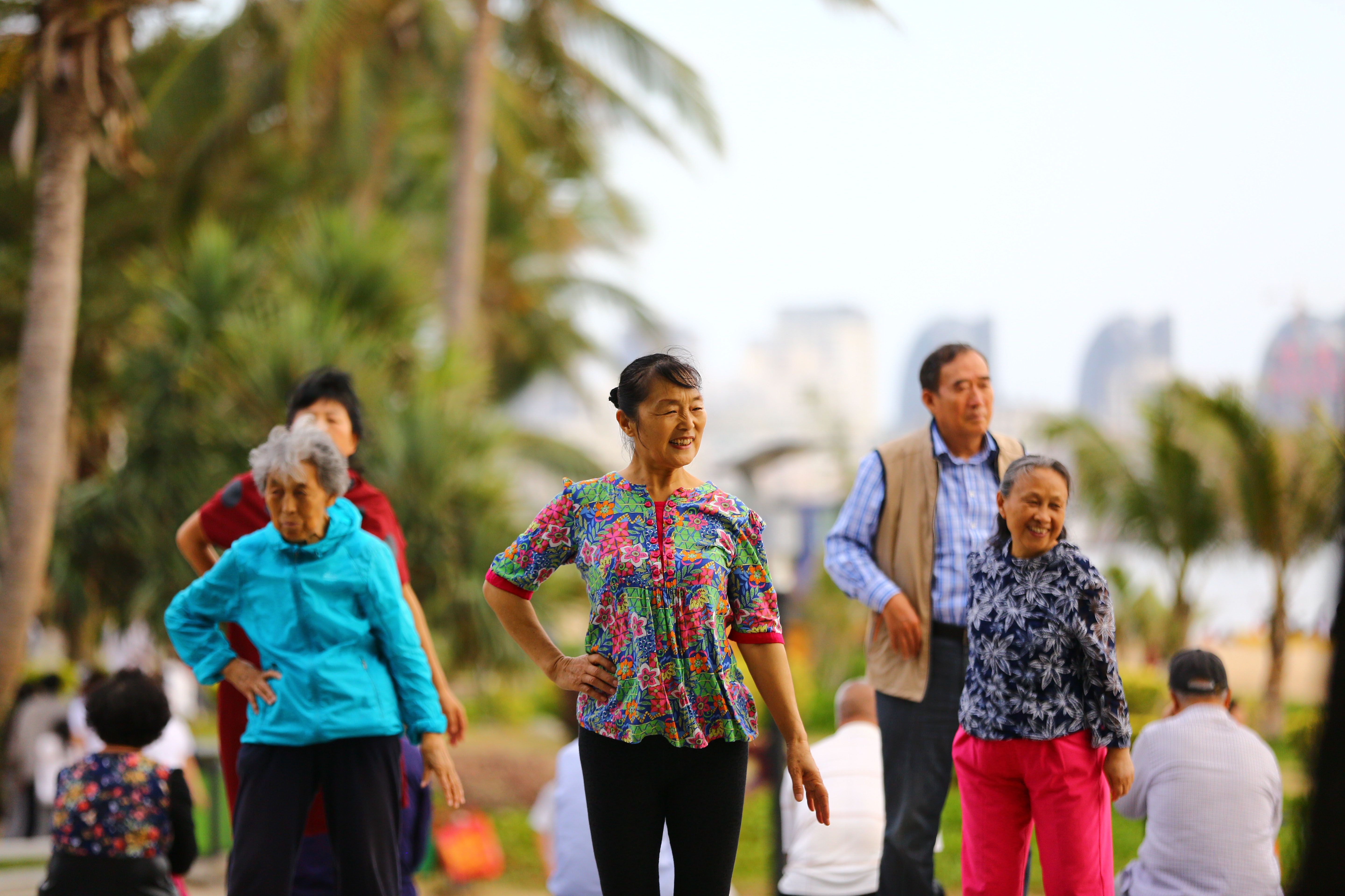 Elderly people walk along the beach in Sanya in China’s Hainan province in February 2017. The island province is fast becoming known as “China’s Florida”, drawing masses of retirees fleeing the biting cold of their hometowns. Photo: AFP