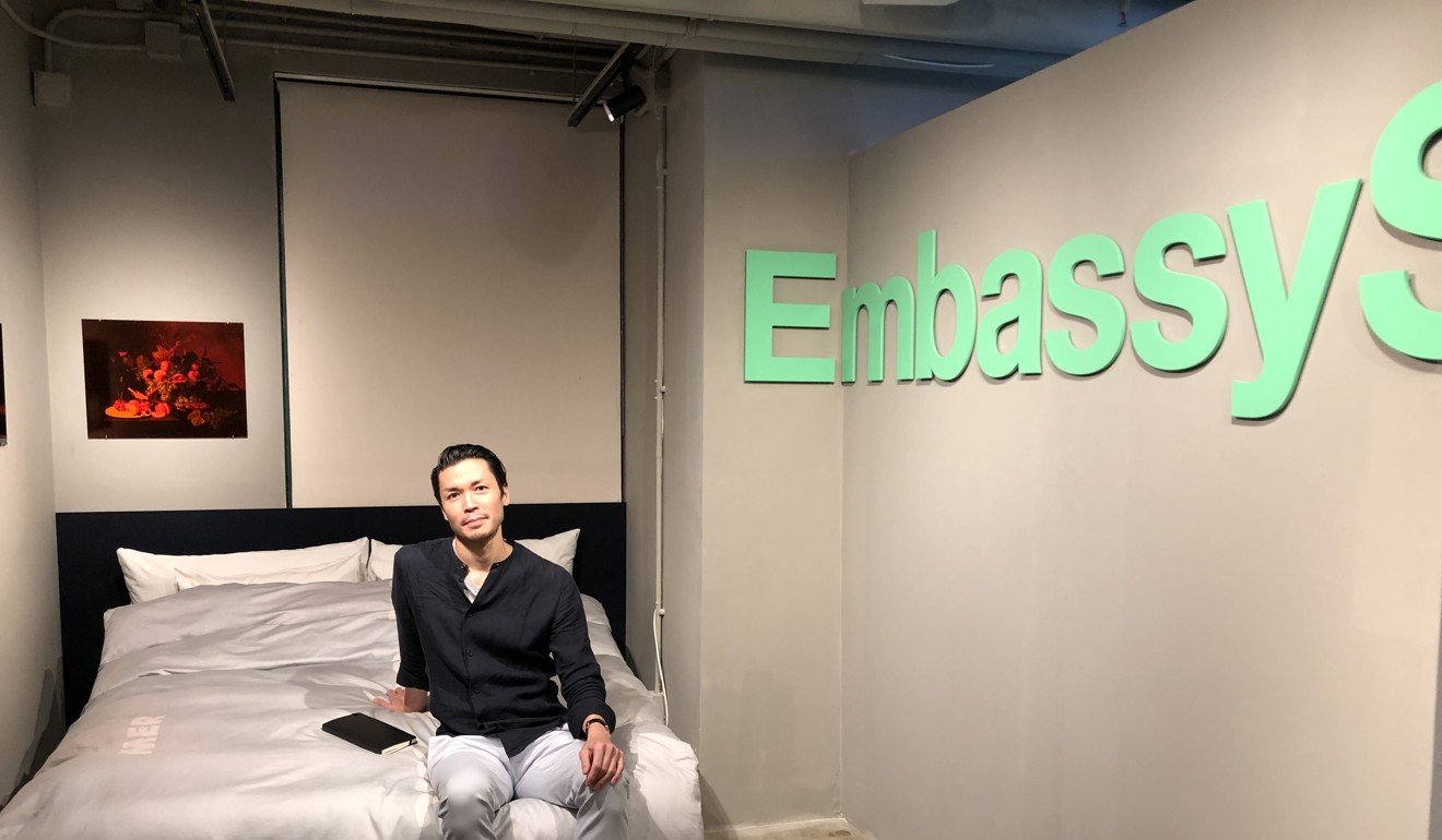 Artist Christopher K. Ho at his exhibition “Embassy S ites” at Tomorrow Maybe, the art space in the Eaton HK hotel in Jordan. Photo: Enid Tsui