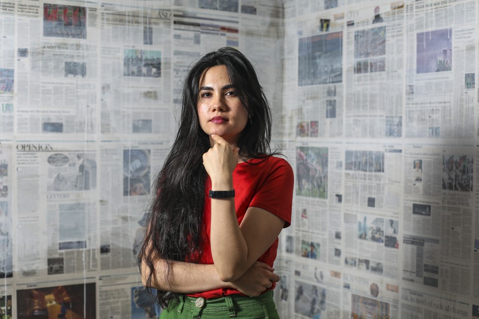 Artist Mandy El-Sayegh at her exhibition in Hong Kong. She covered the walls in newspaper pages to represent the environment that shapes personal identity. Photo: Xiaomei Chen