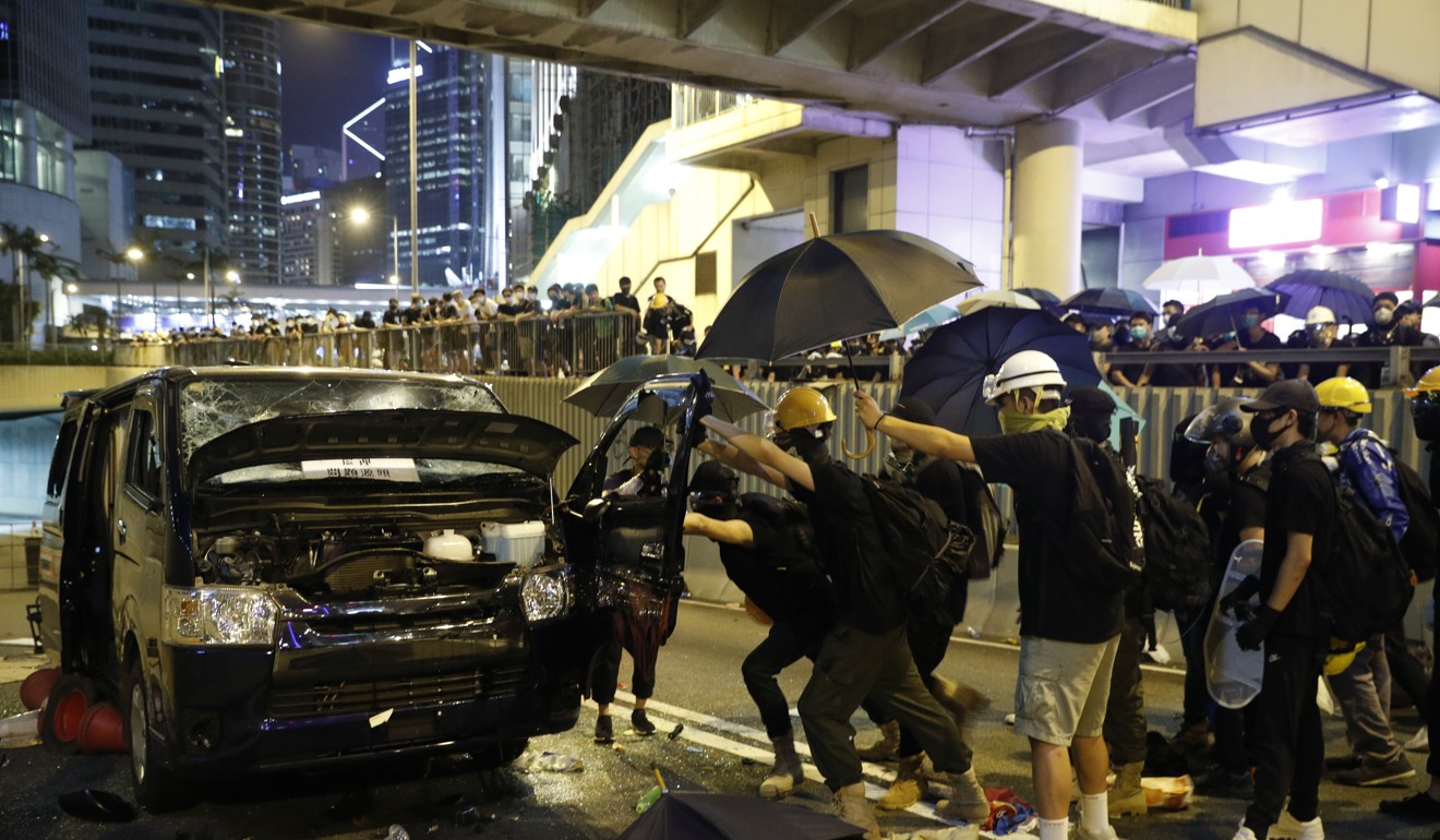 Protesters attack a van on July 21. Photo: AP