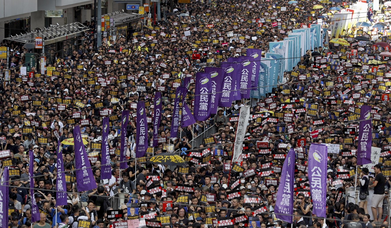 Protesters take part in a march on a street in Hong Kong on July 21. Photo: AP