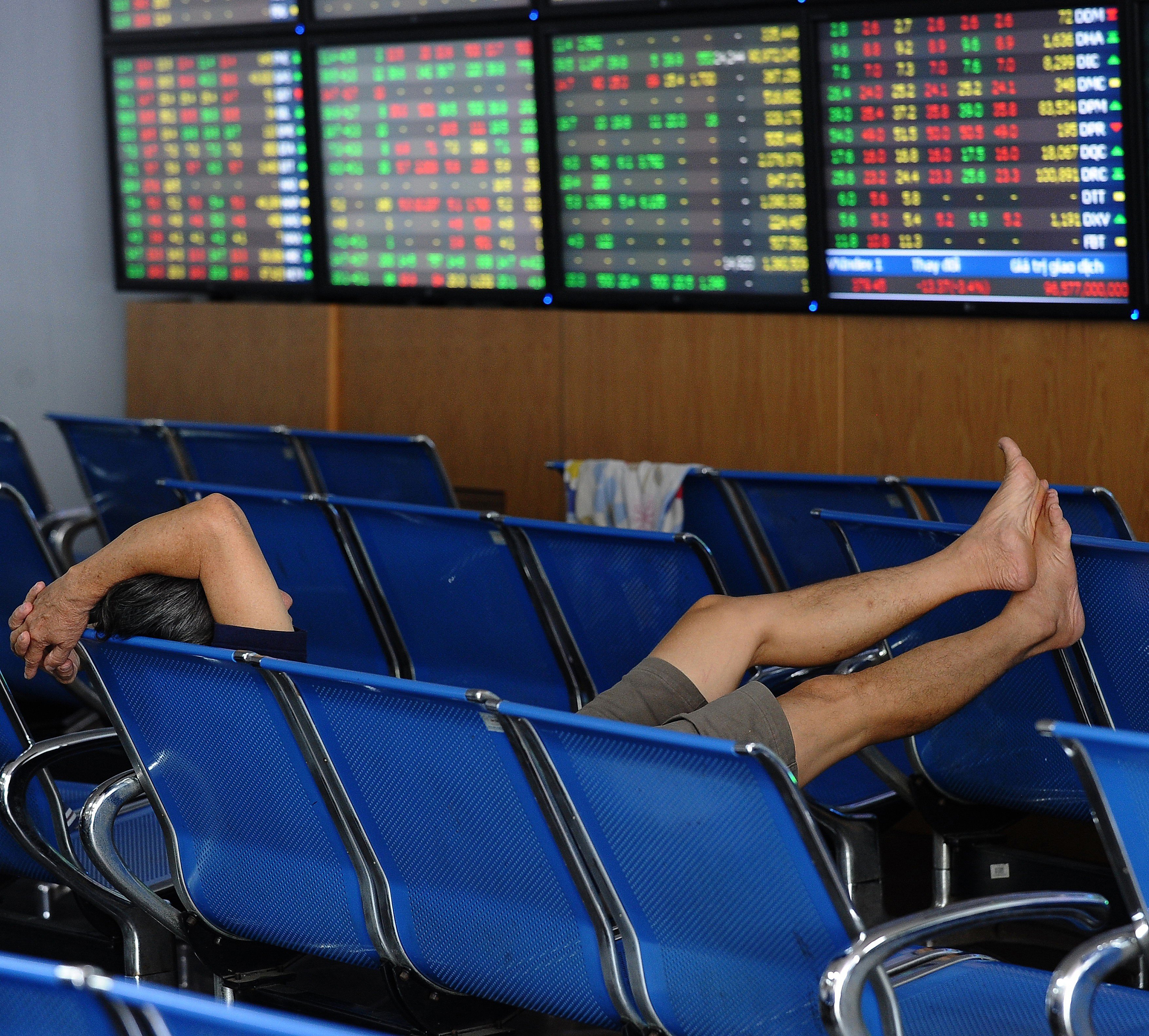 A Vietnamese investor watches share price activity on a securities trading floor in Hanoi. Photo: AFP