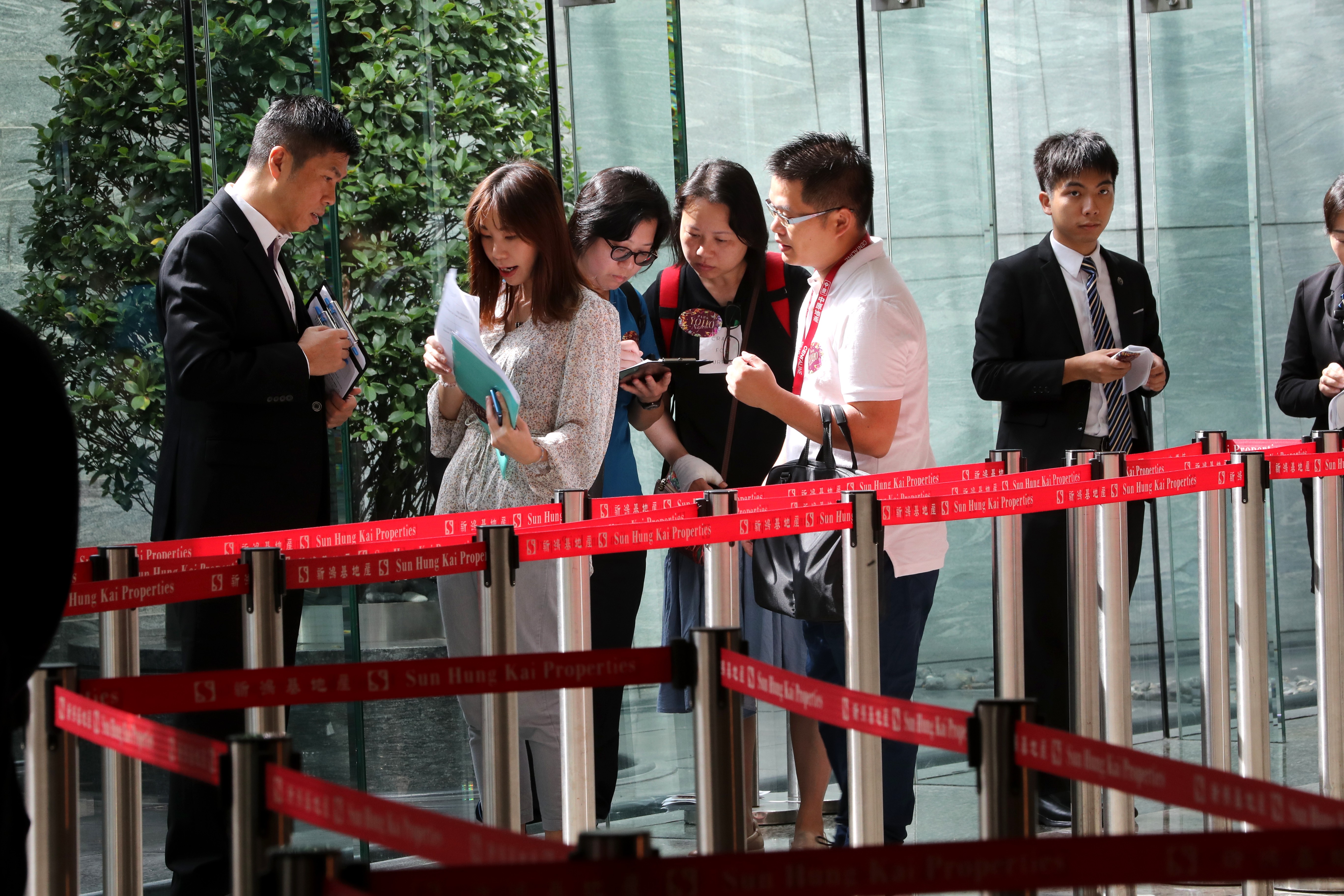 Potential buyers queues for Sun Hung Kai Properties' 145 units at Park Yoho Napoli on 27 July 2019. Photo: SCMP / Edward Wong