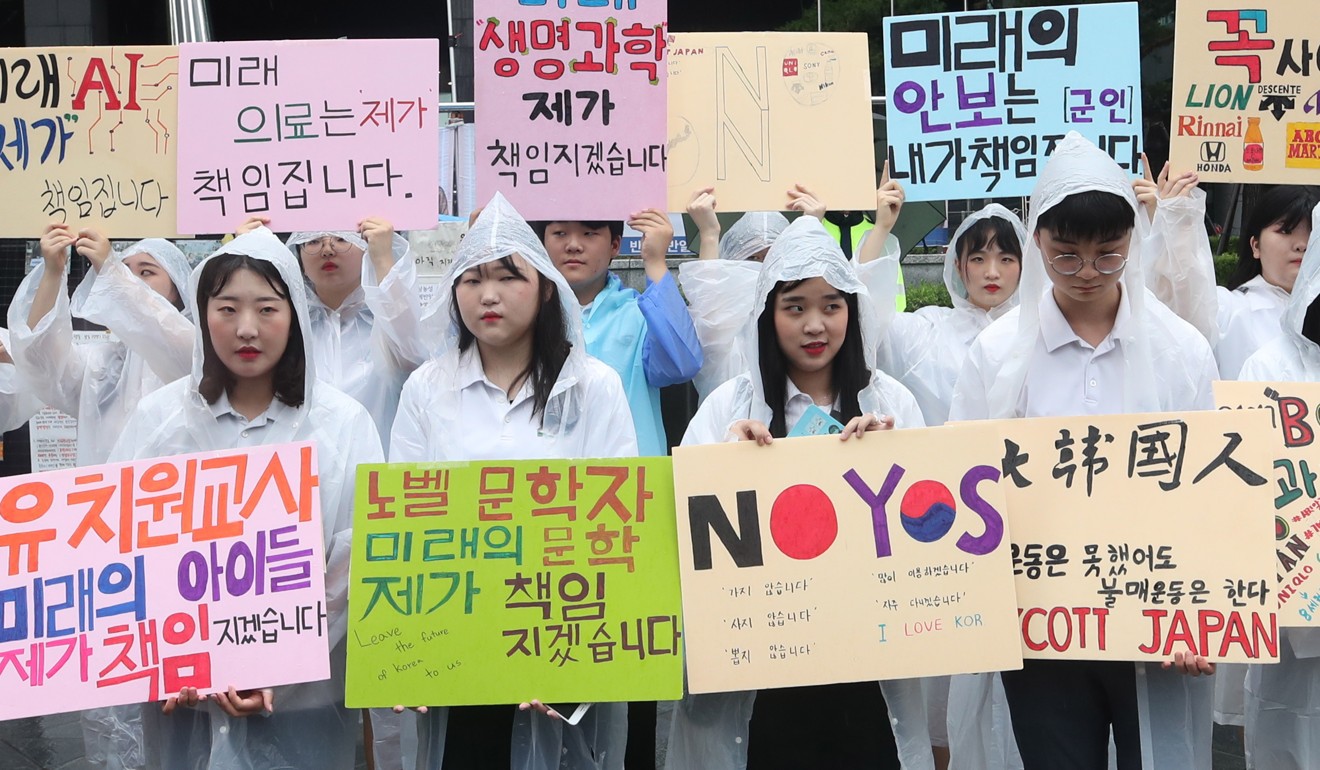 Students from high schools in Gyeonggi province hold up ‘boycott Japan' signs in front of the Japanese embassy in Seoul. Photo: EPA