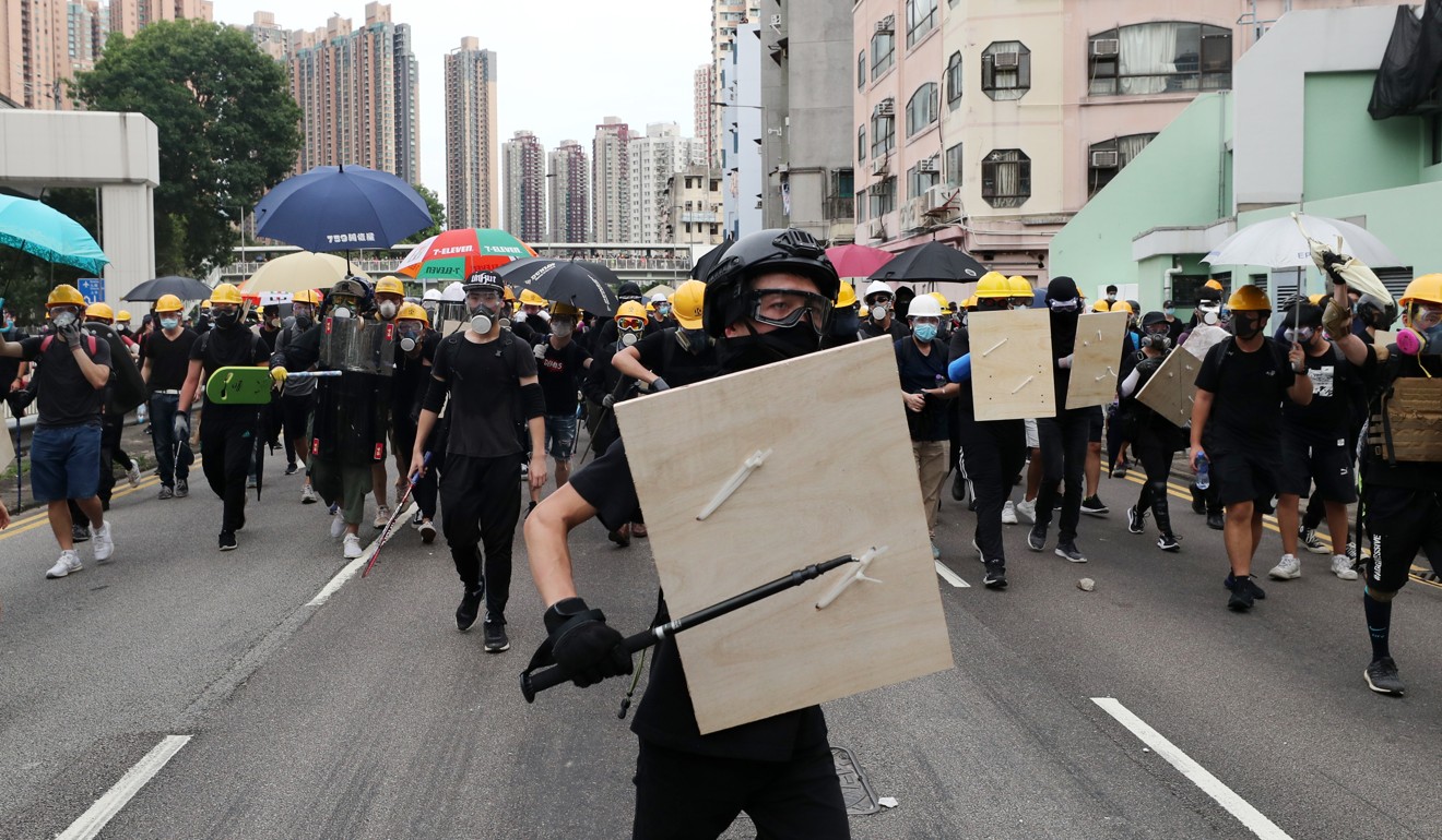 The protesters, dressed in black, came prepared with masks and protective gear. Photo: Sam Tsang