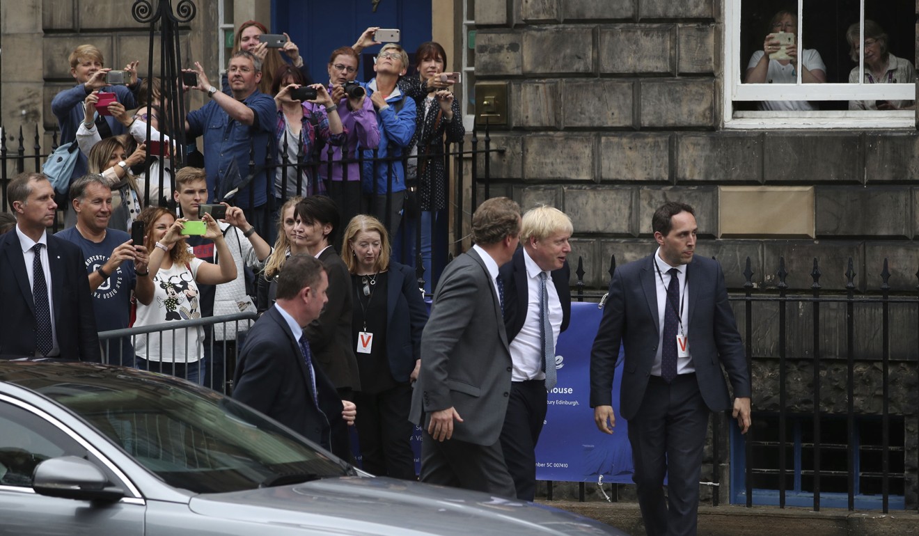 Britain's Prime Minister Boris Johnson (second from right) arrives to meet outside Bute House in Edinburgh to meetScotland's First Minister Nicola Sturgeon on Monday. Photo: PA via AP