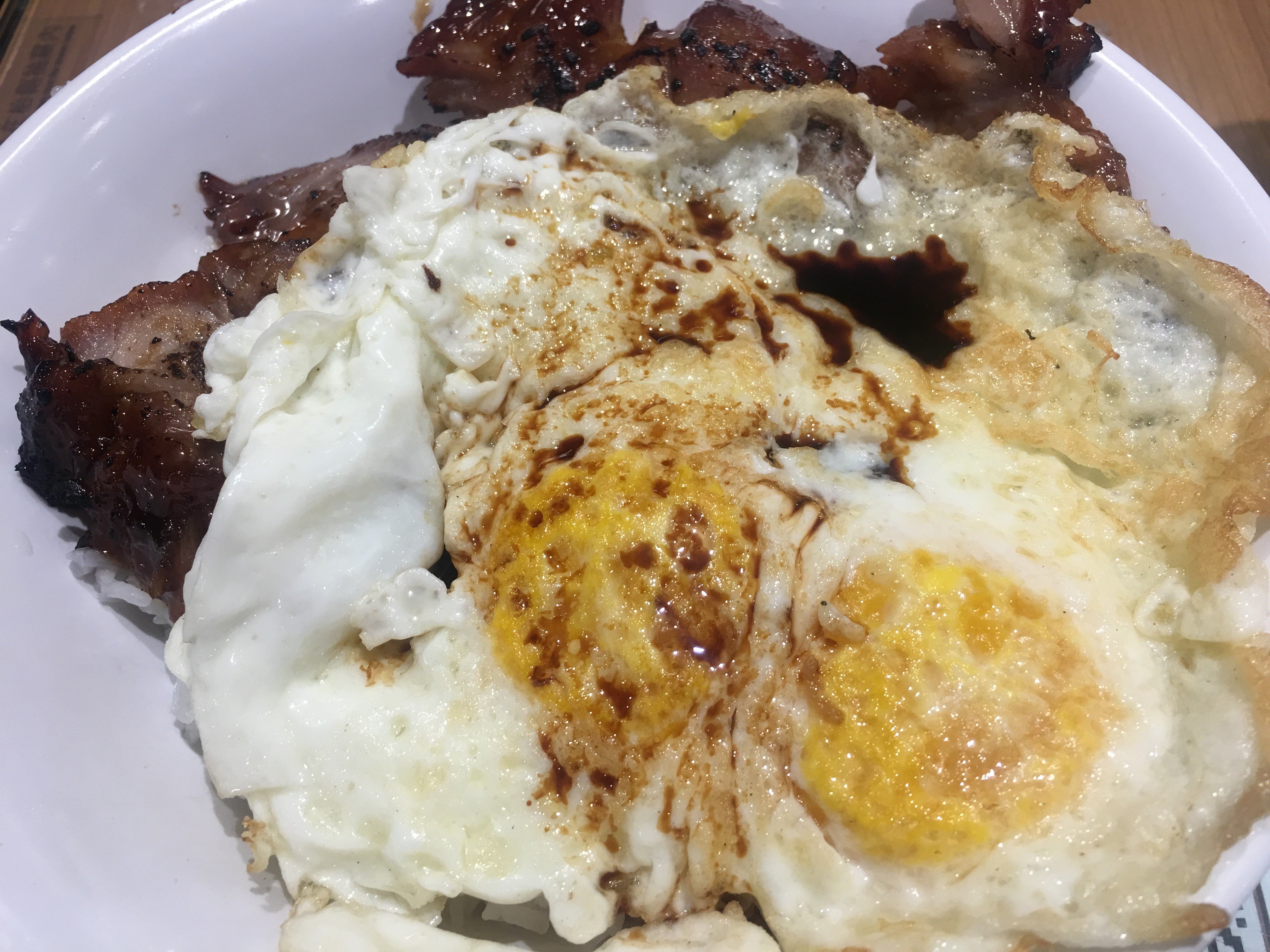 “Sorrowful rice” - slices of barbecue pork on a bed of rice with a fried egg on top - at Men Wah Bing Teng