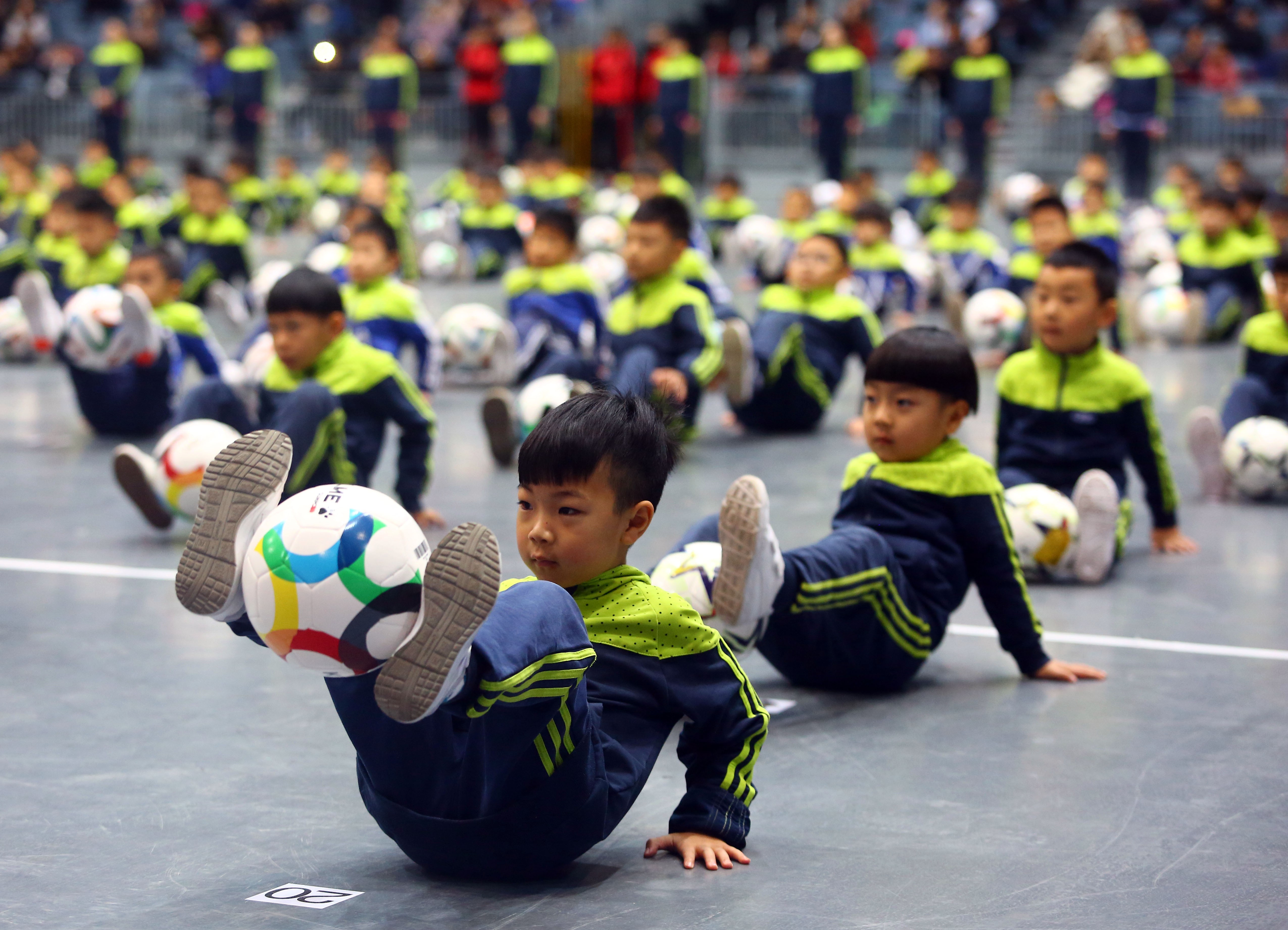 Children playing with their footballs at a gymnasium in Tianjin on December 16, 2017. Photo: Xinhua