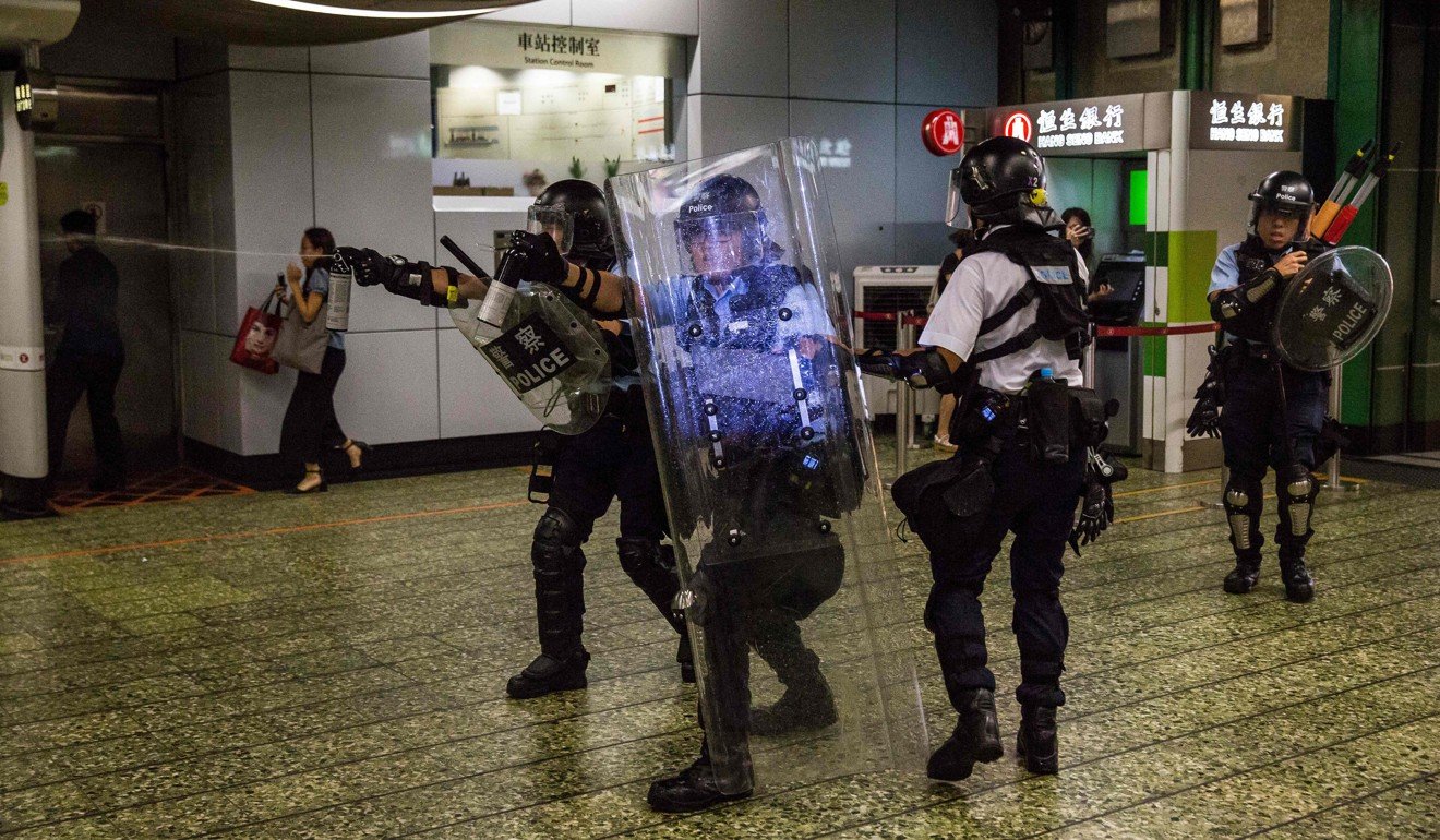 Police use pepper spray during clashes with protesters outside Kwai Chung Police Station. Photo: AP