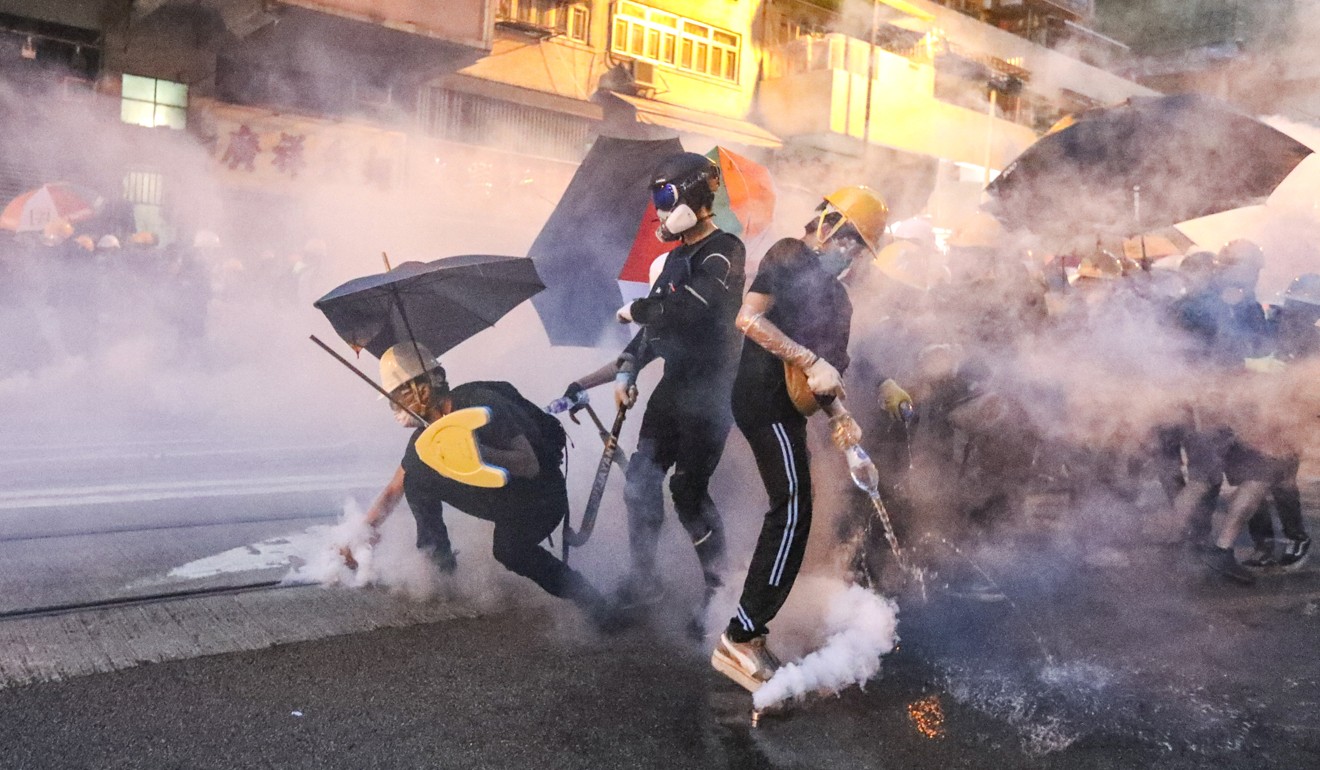 Riot police fire tear gas at anti-government protesters in the Western district of Hong Kong. Photo: Felix Wong