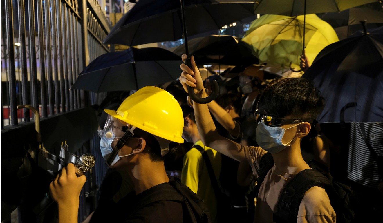 Demonstrators surround a Hong Kong police station where protesters are being held on Wednesday. Photo: Reuters