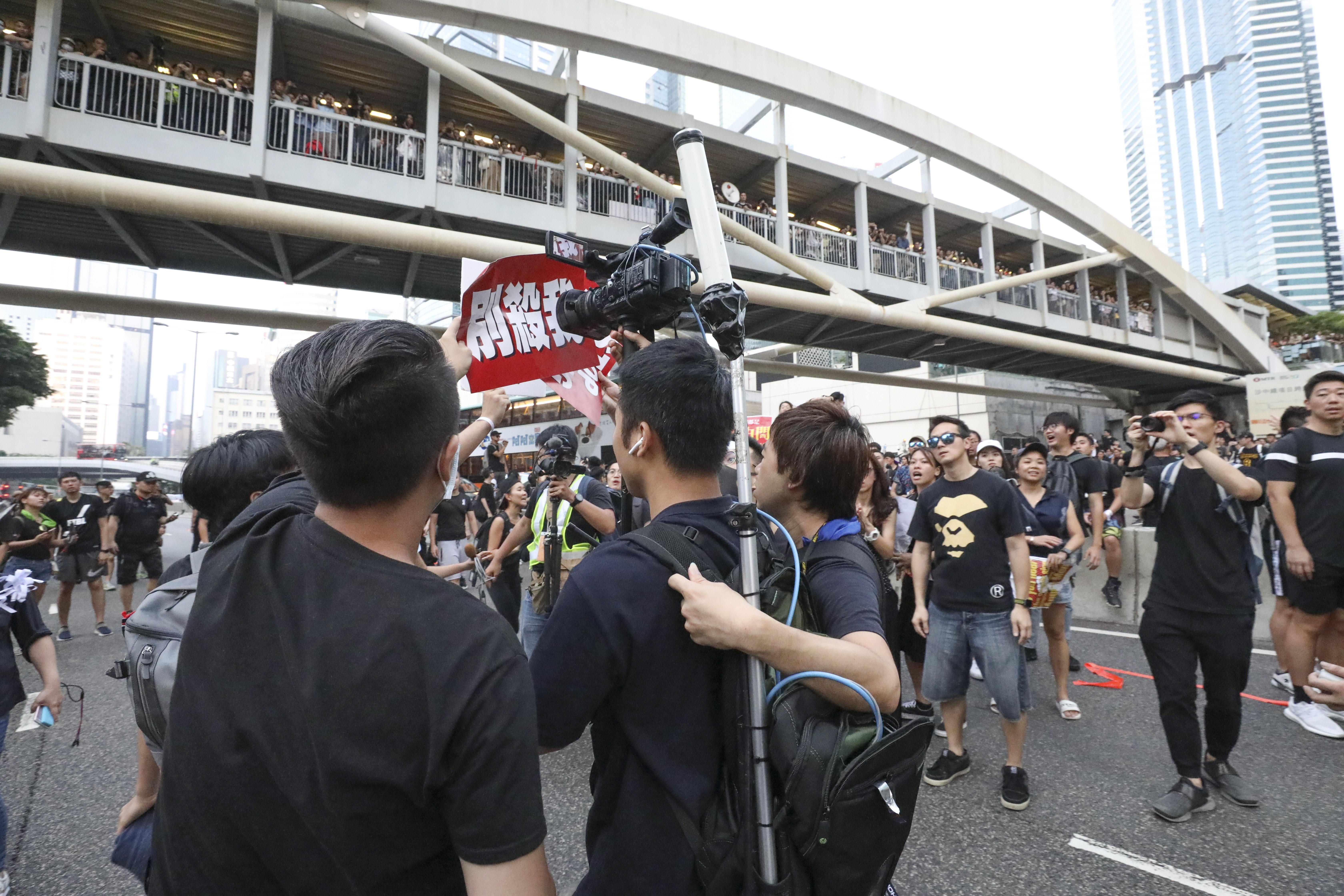 A TVB cameraman is harassed and pushed out of the protest zone during a rally in Tamar on June 16. Hong Kong netizens who accuse TVB of biased reporting and call for a boycott of the broadcaster are becoming as extreme as the mainland internet vigilantes who forced Lancôme to cancel Denise Ho’s concert. Photo: Antony Dickson