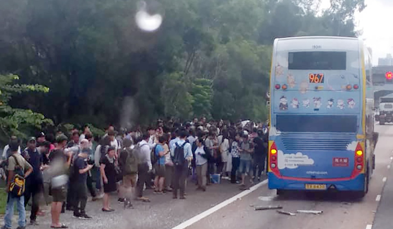 Passengers, many of whom are injured, wait by the side of the road near the Tsuen Wan exit of Tai Lam Tunnel. Photo: Facebook
