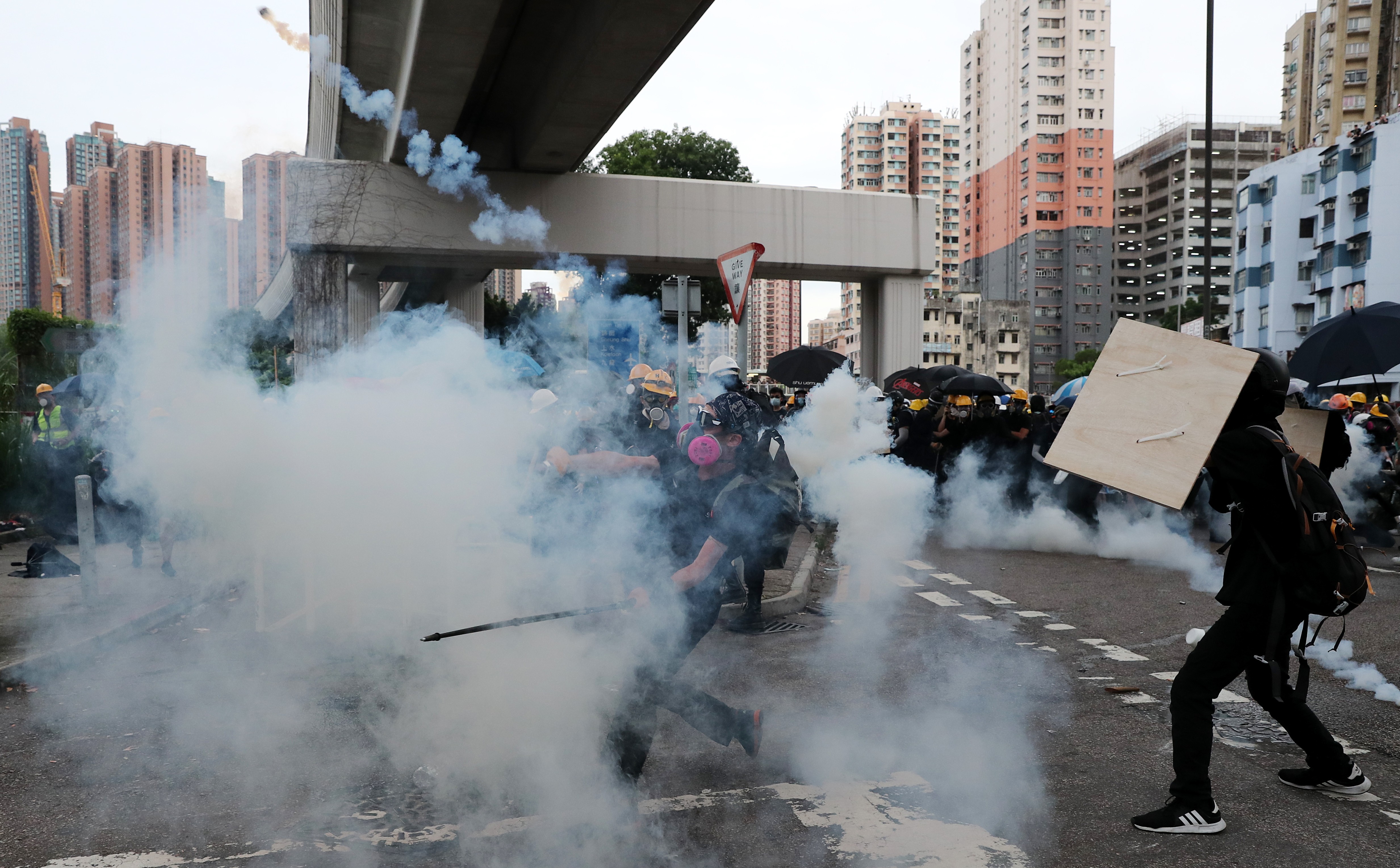 A protester throws a tear-gas canister back at police during clashes in Yuen Long. Photo: Sam Tsang