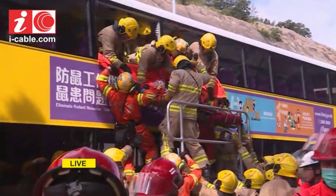 Firemen and medics rescue passengers from the bus in dramatic television footage. Photo: Cable TV News