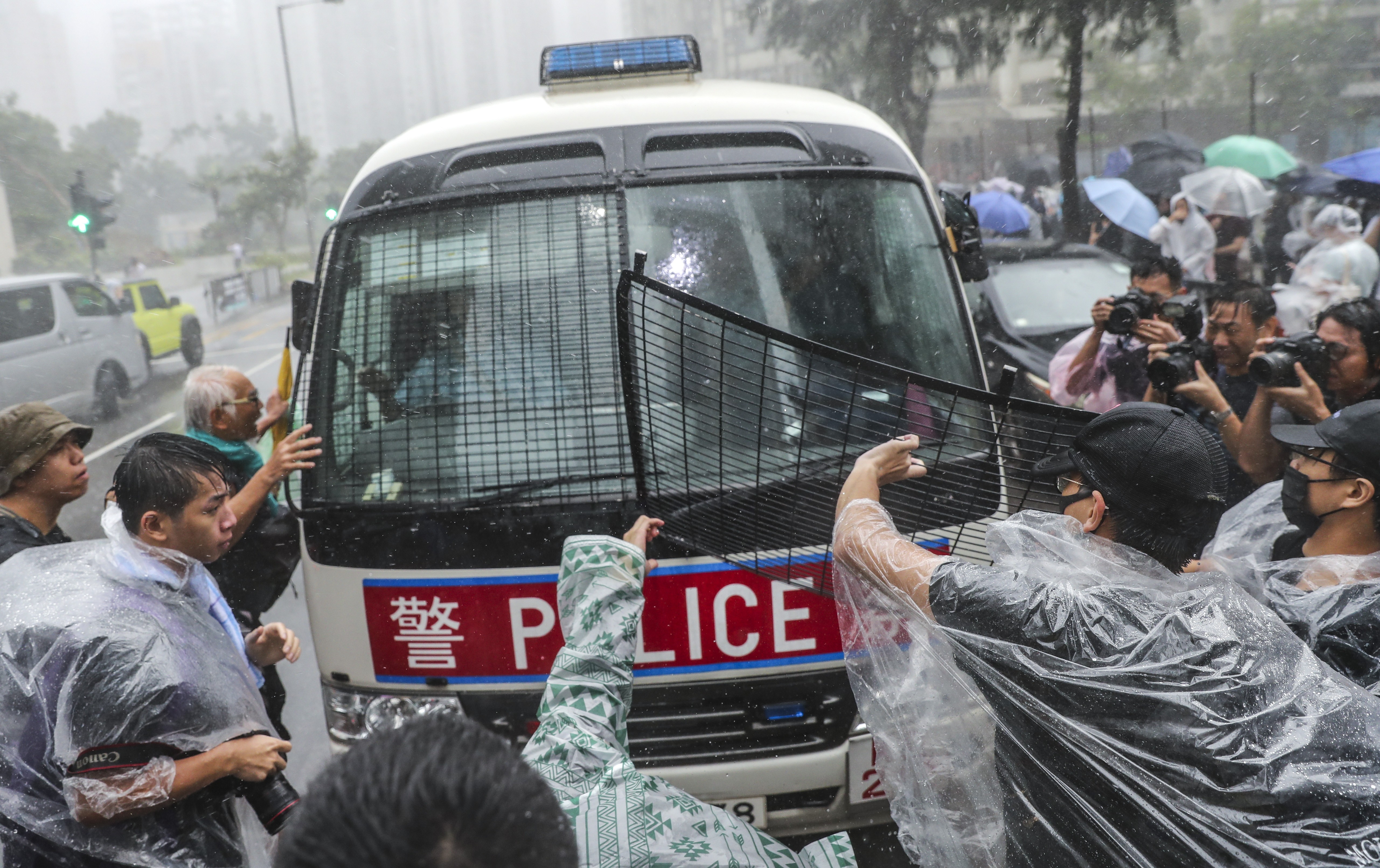 Protesters attack a police van outside the Eastern Court in Sai Wan Ho, where 44 people charged for rioting appeared before magistrates on Wednesday. Photo: Sam Tsang