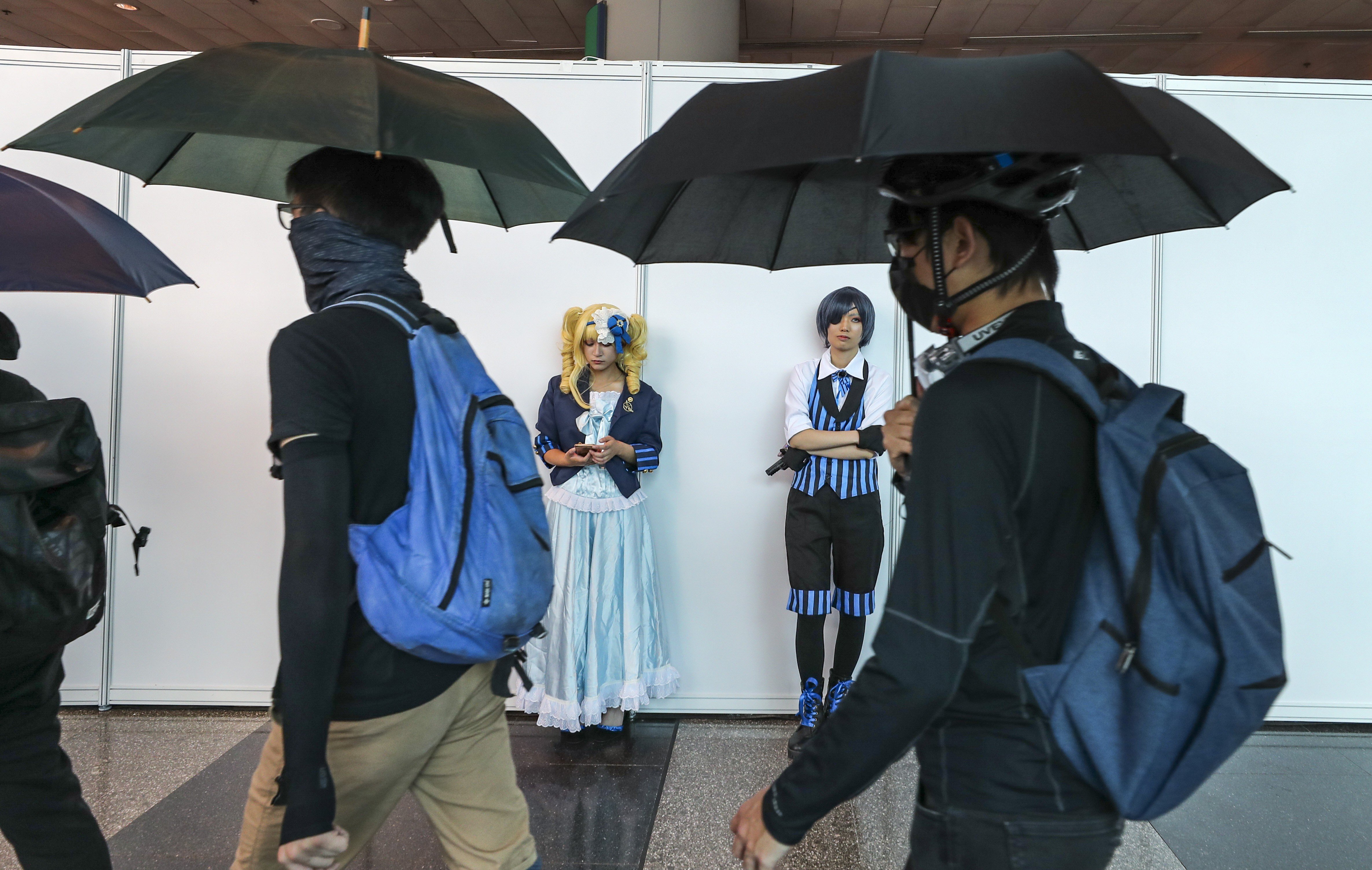 Trade show organisers are concerned that prolonged civil protests will put a damper on visitor numbers at upcoming events this autumn. Protesters at the convention centre in Wan Chai march during an animation, comics and games expo on July 28, 2019. Photo: Sam Tsang