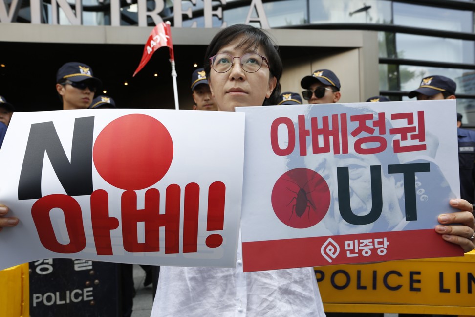 South Korean protesters hold up anti-Abe banners during a protest in Seoul. Photo: EPA-EFE