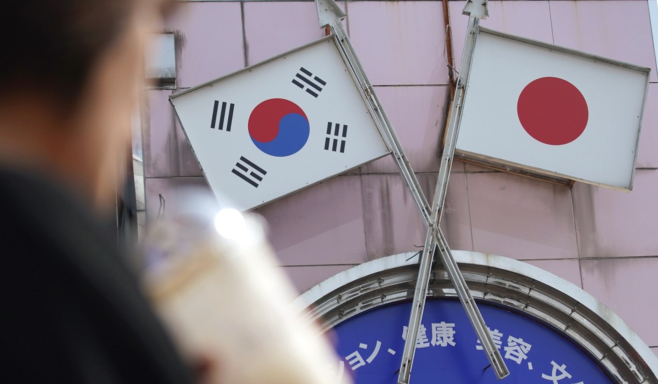 Japanese and South Korean flags seen in Tokyo. Photo: AP